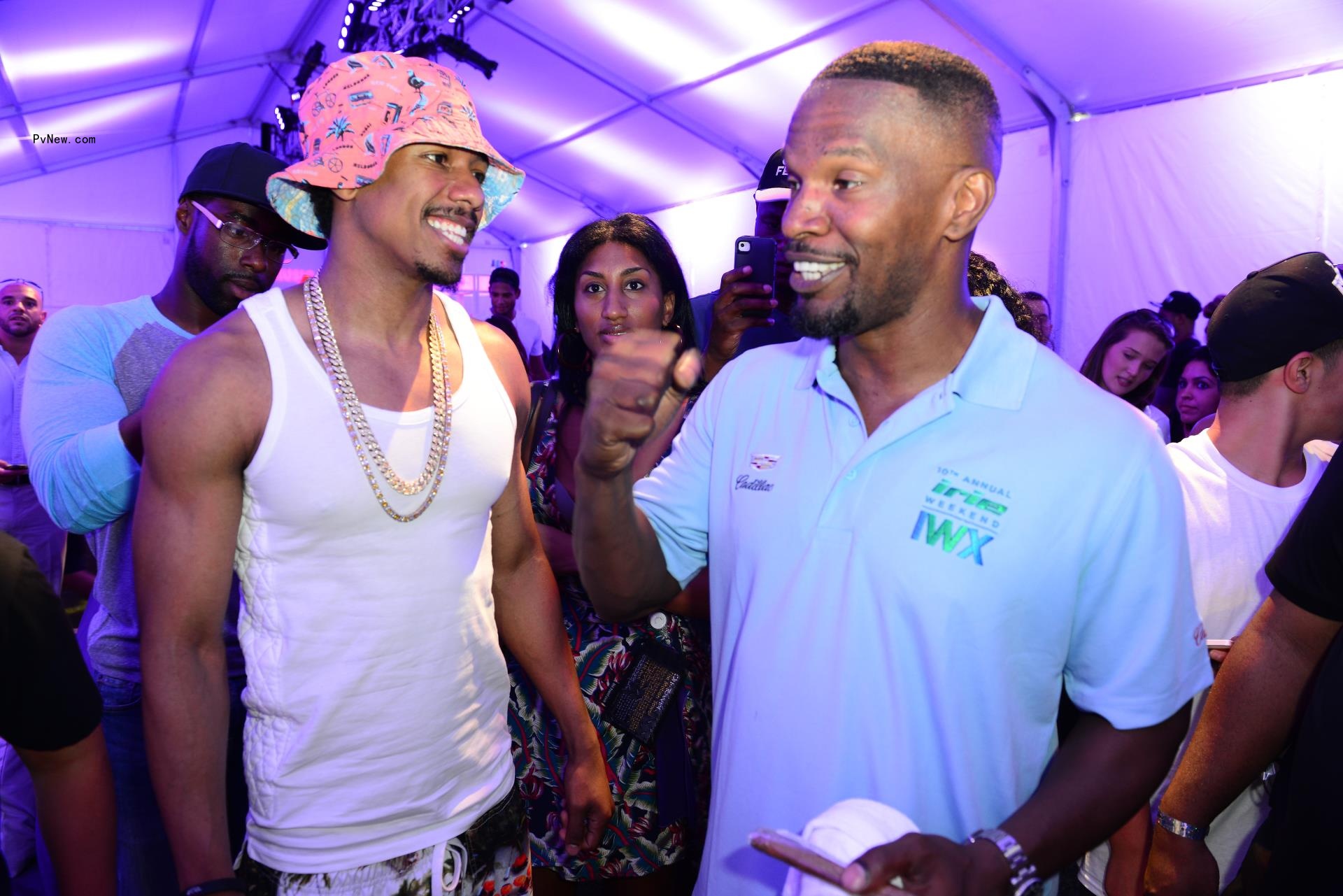 Nick Cannon smiles at Jamie Foxx