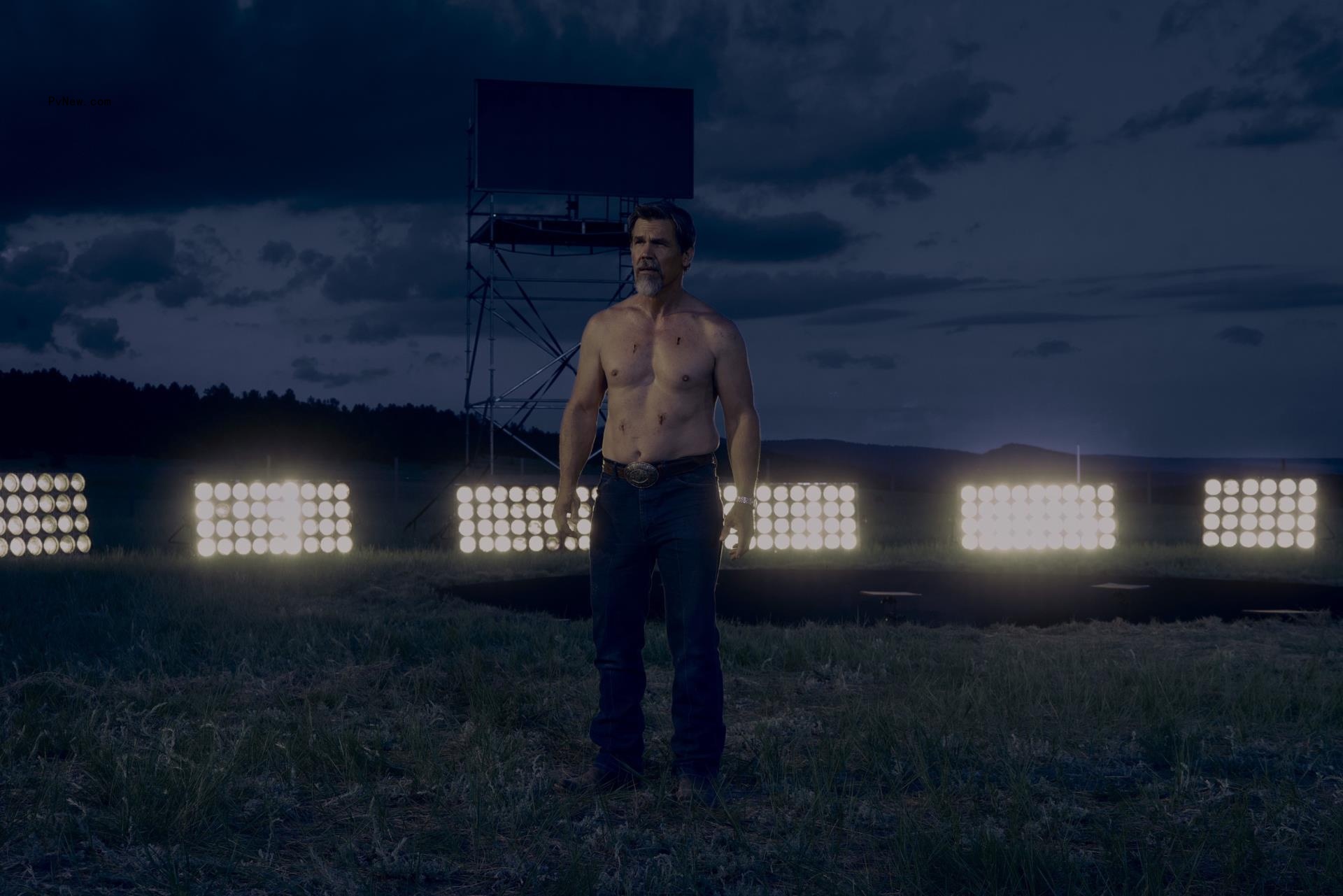 Josh Brolin standing shirtless