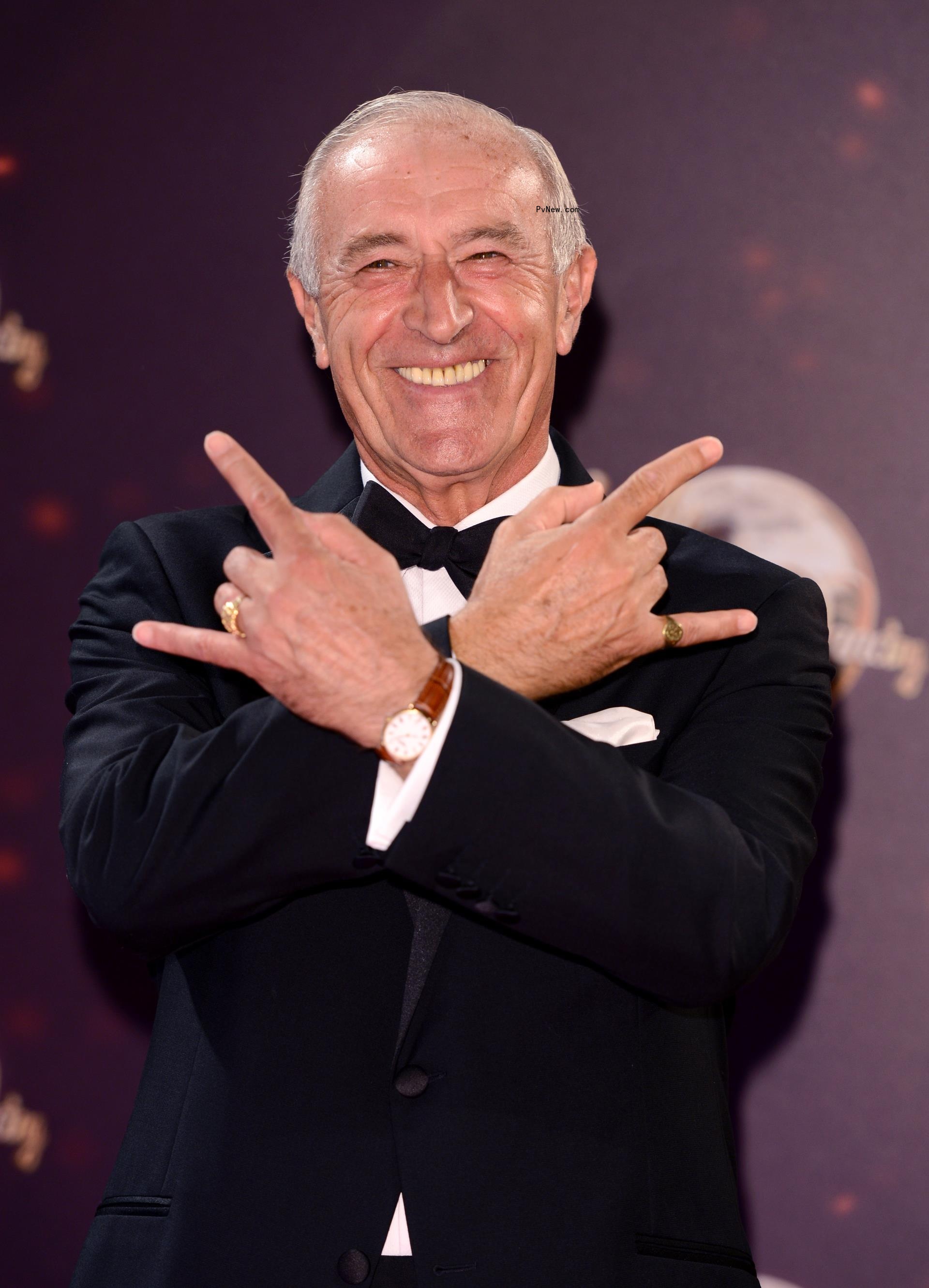 Len Goodman smiles in suit on red carpet