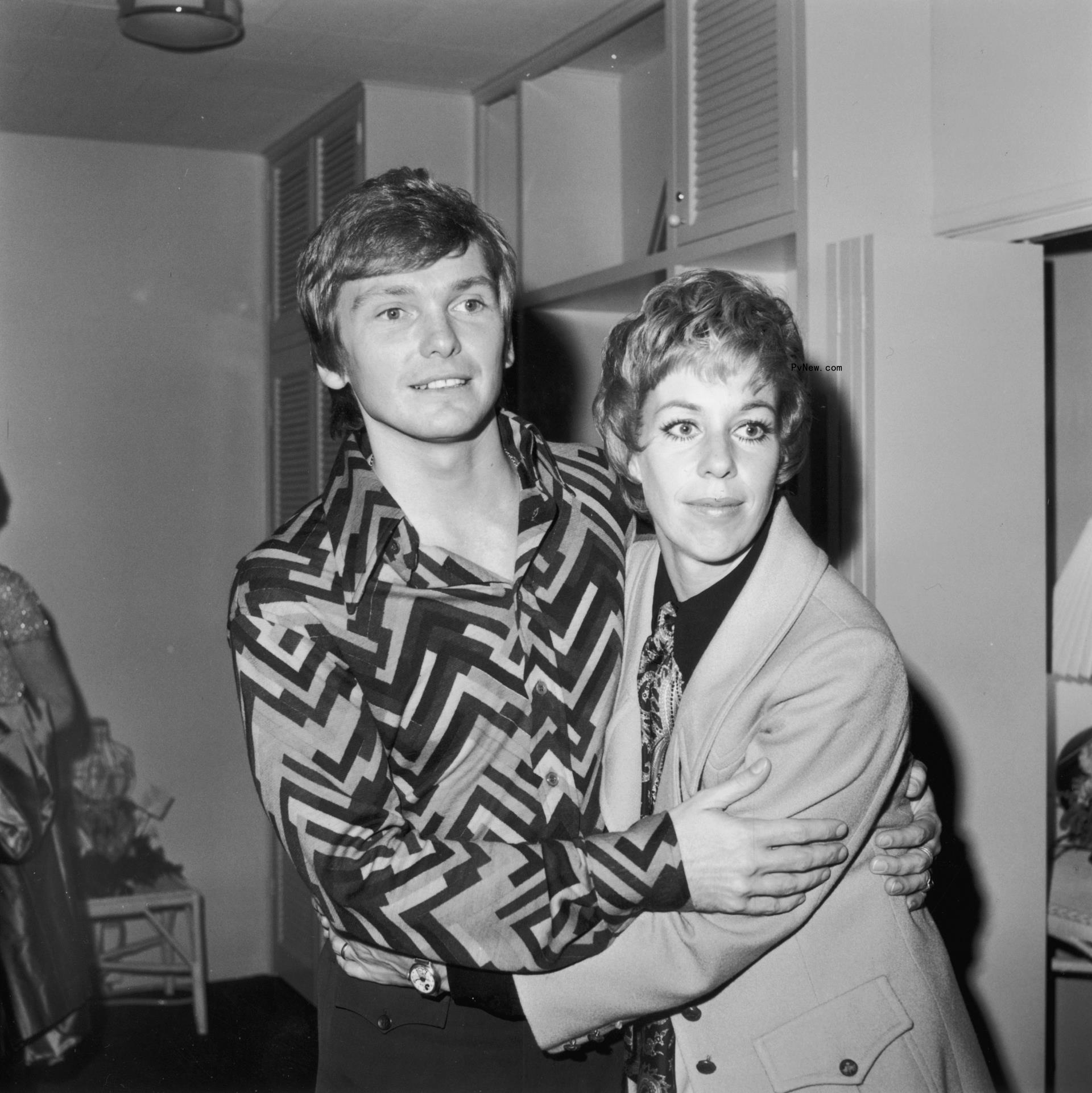 Bob Mackie and Carol Burnett hugging in 1969.