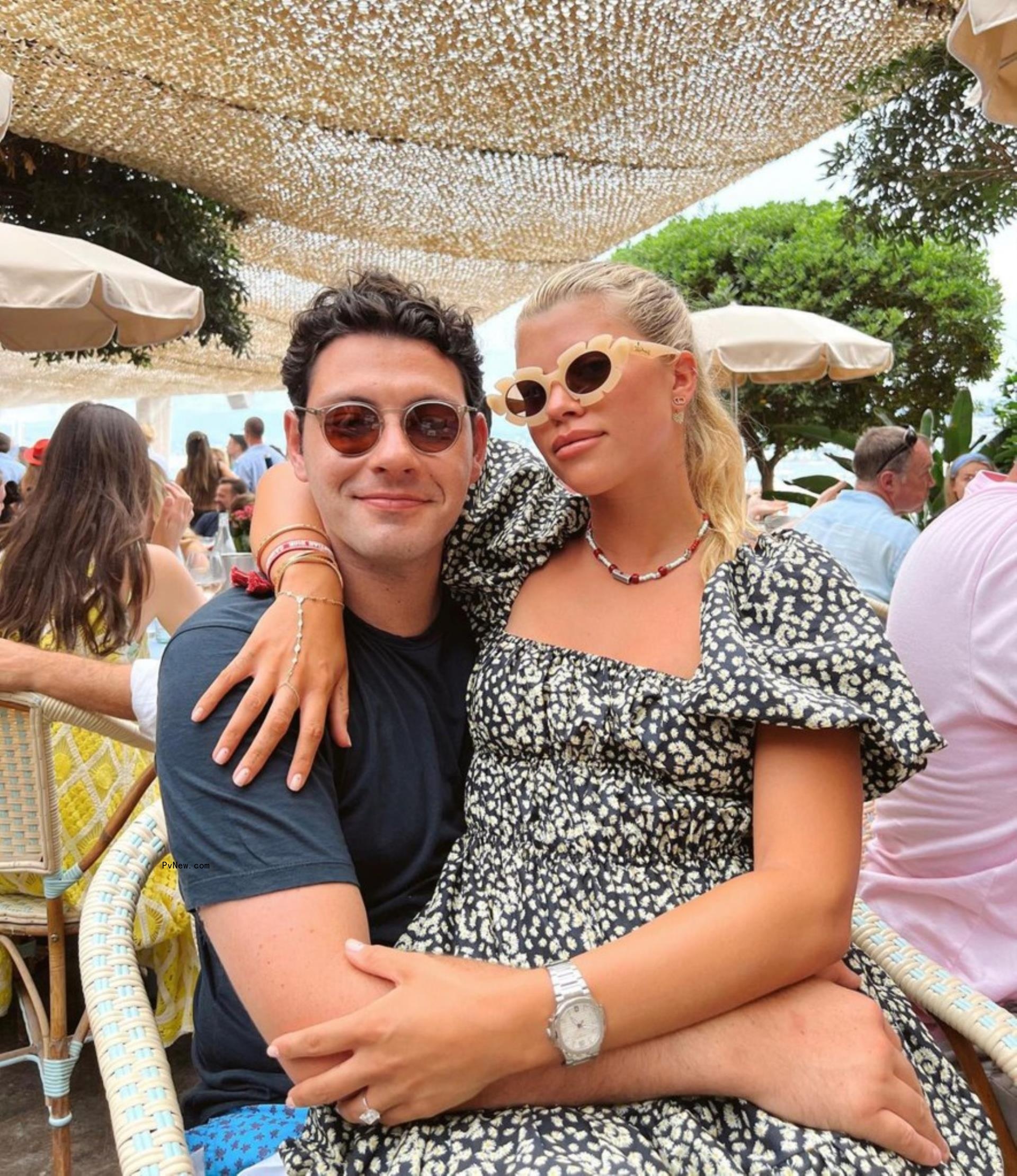 Sofia Richie sitting on Elliot Grainge's lap.