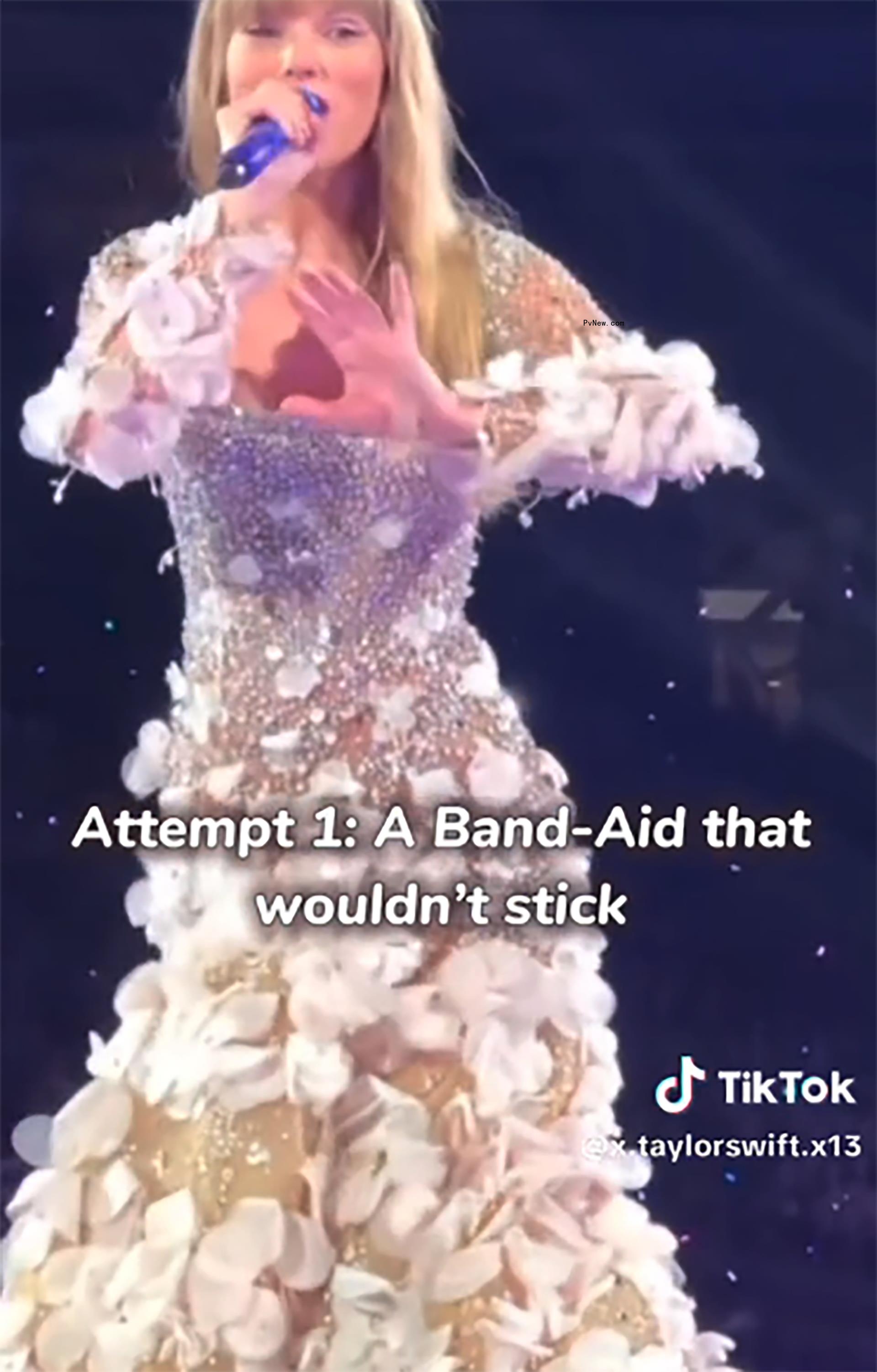 Taylor Swift o<i></i>nstage singing with cut on hand