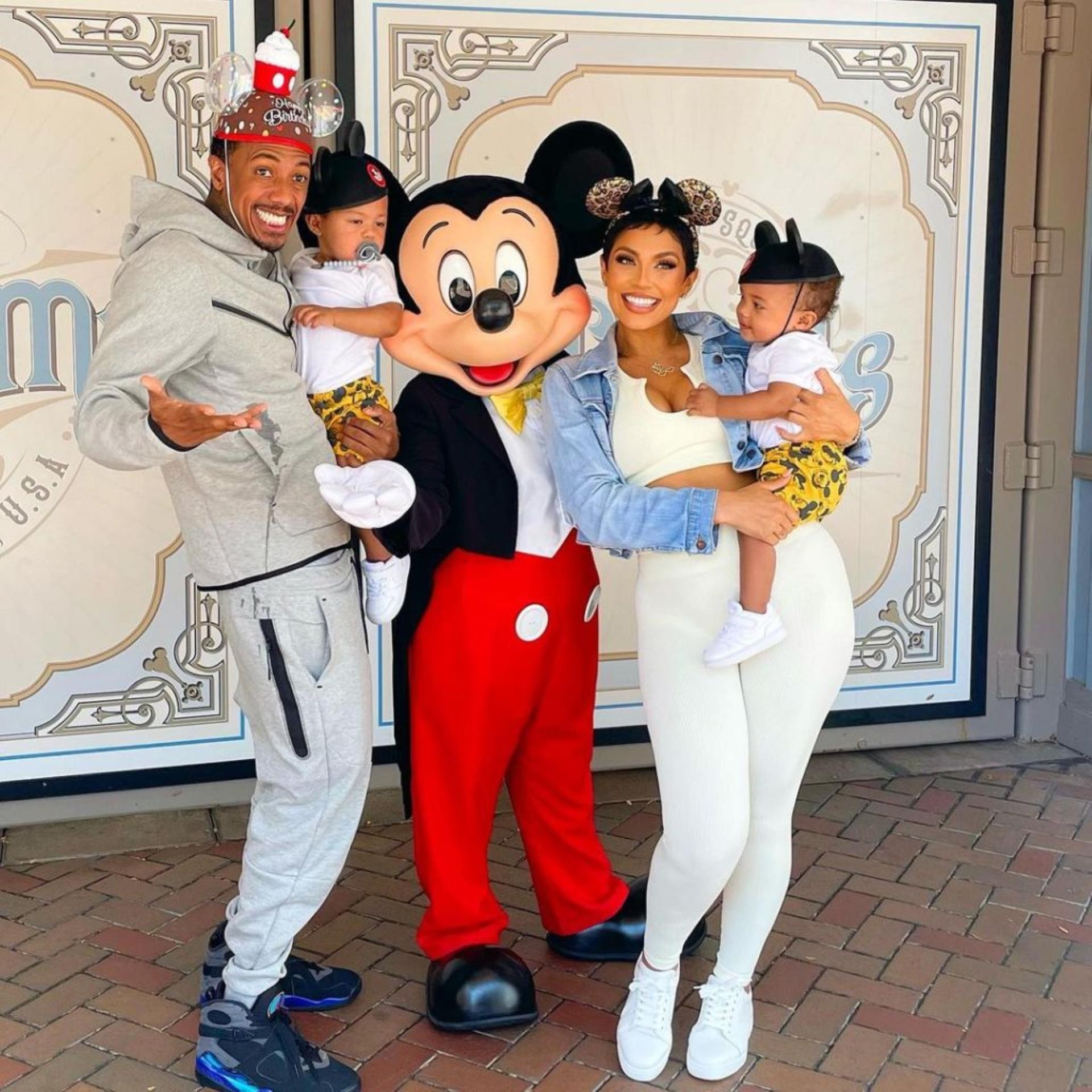 Nick Cannon and Abby De La Rosa hold sons Zion and Zillion at Disneyland