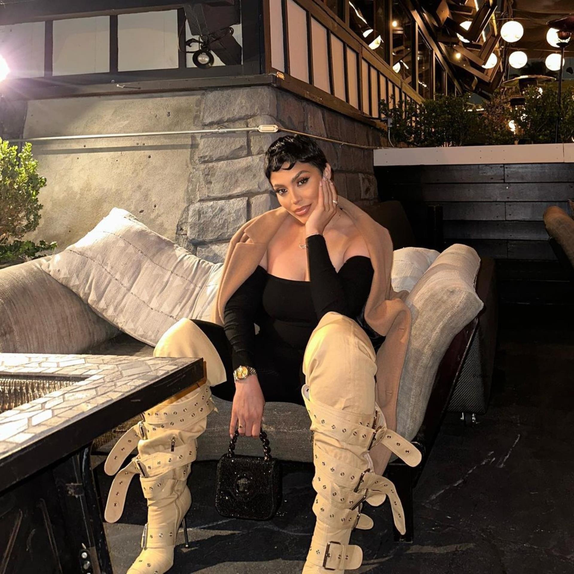 Abby De La Rosa sits on couch