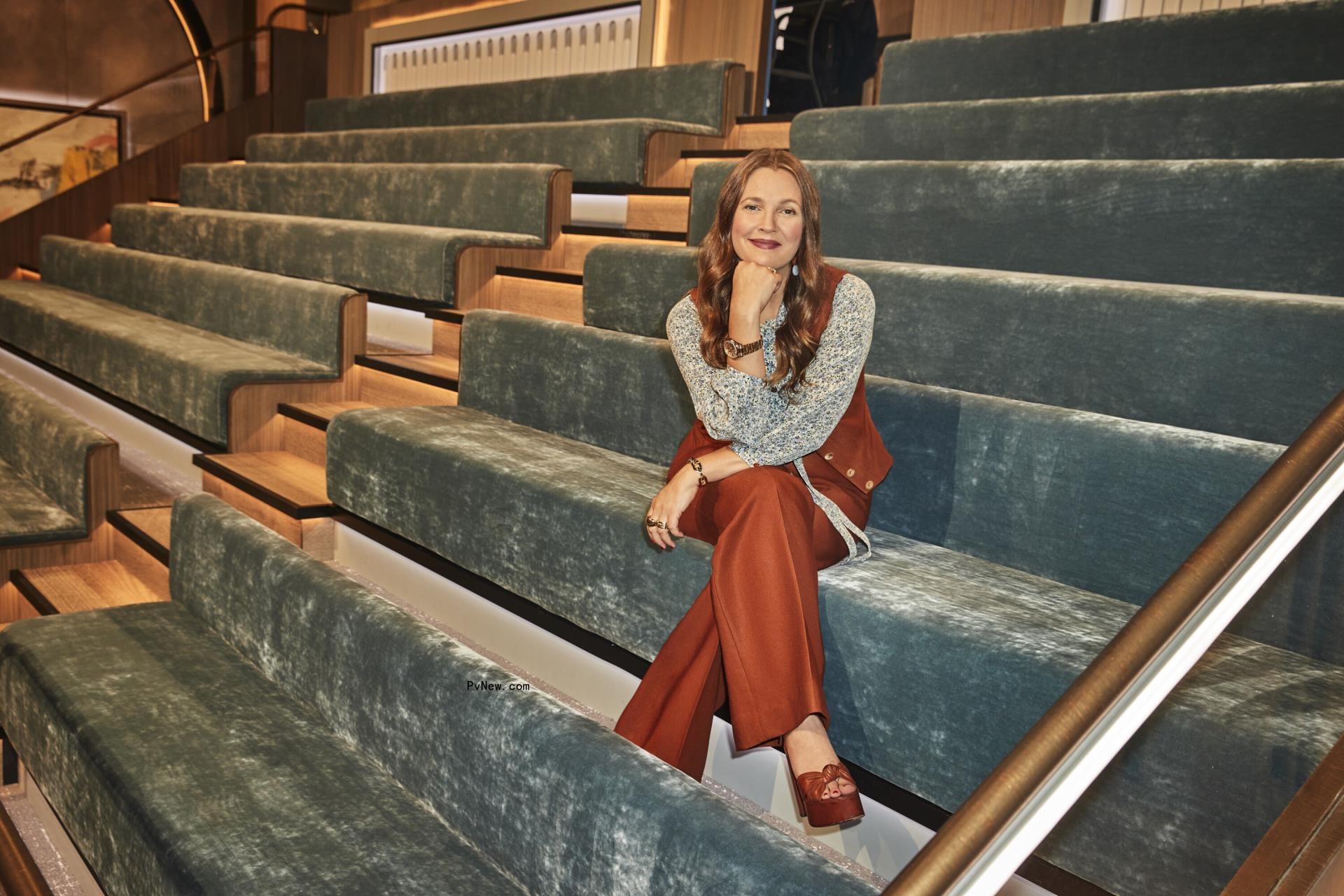 Drew Barrymore sitting on the stairs. 