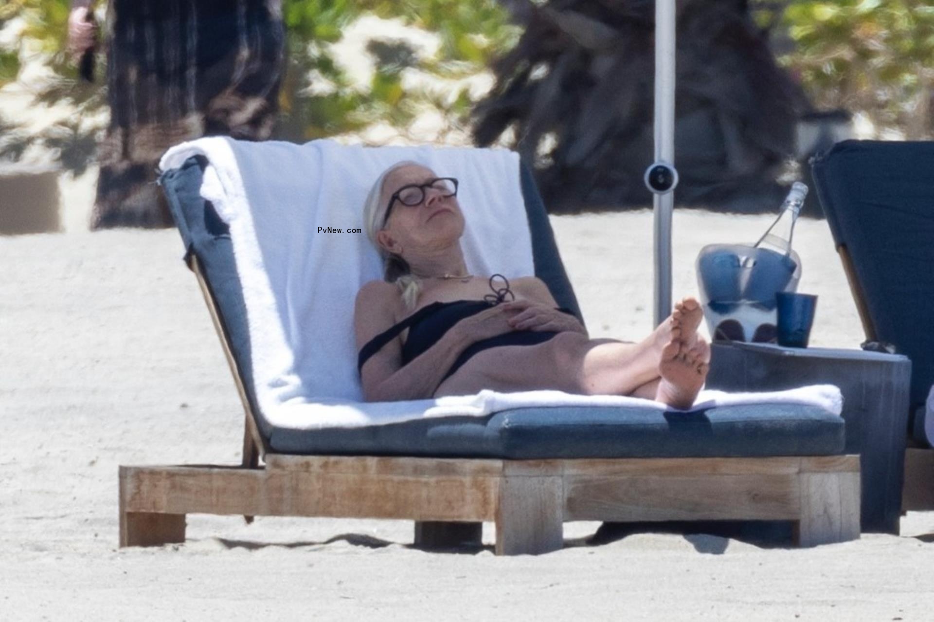 Helen Mirren lounging in a beach chair.