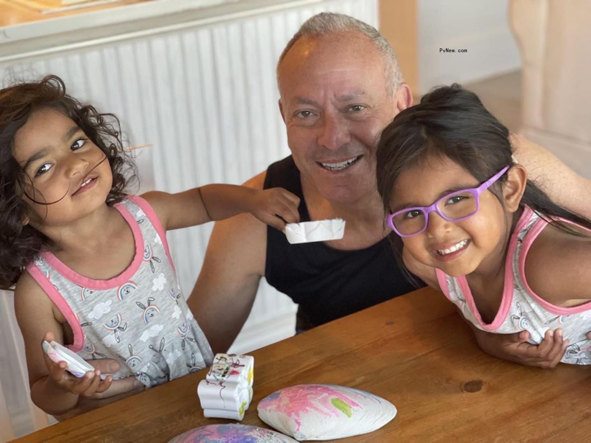 Joel Schiffman smiles with daughters Haley and Hope