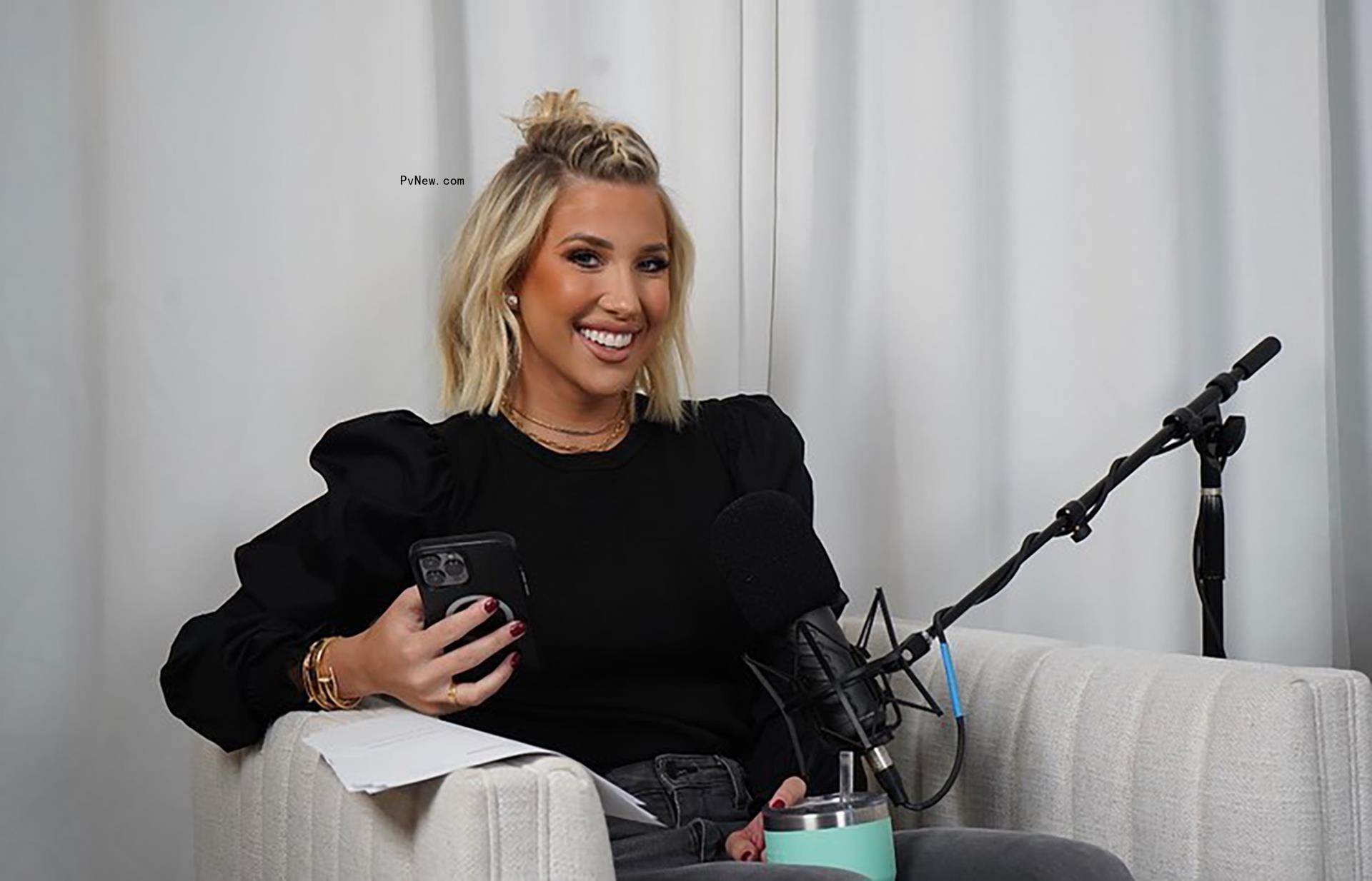 Savannah Chrisley smiles on white armchair