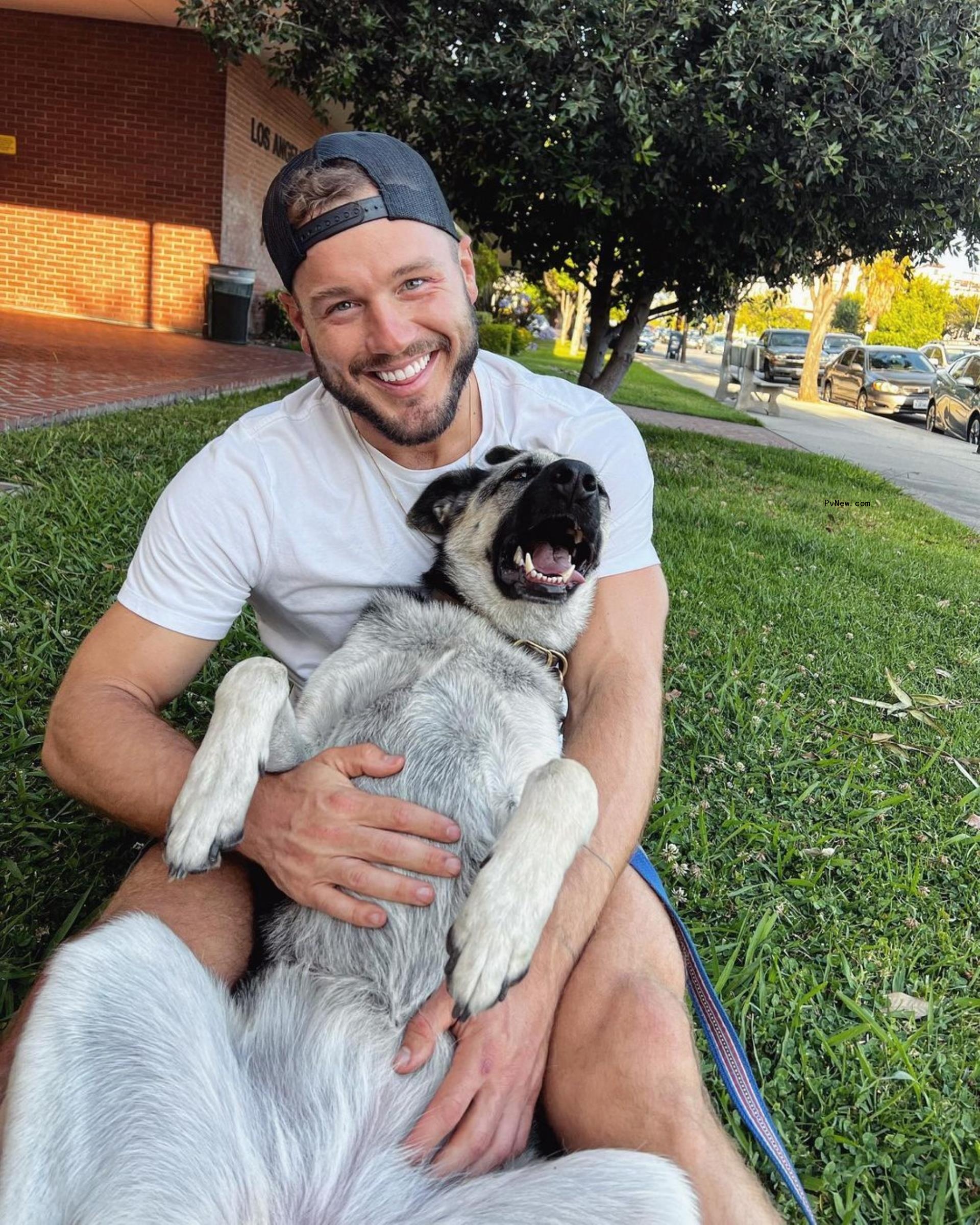 Colton Underwood smiles with dog