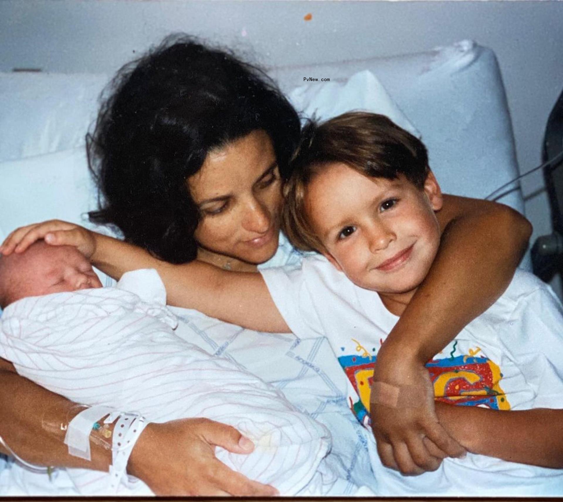 Julia Louis-Dreyfus holds sons in bed