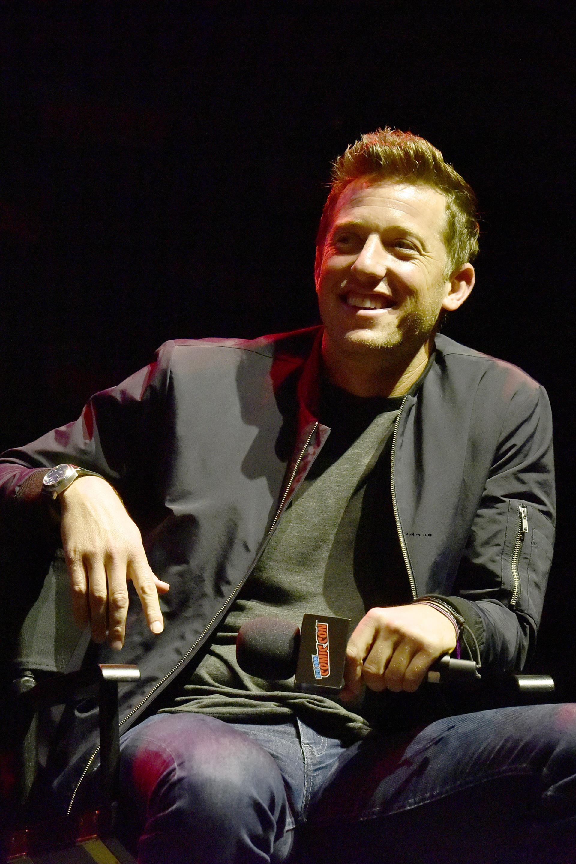 Matt Kaplan sitting down on stage at an event 