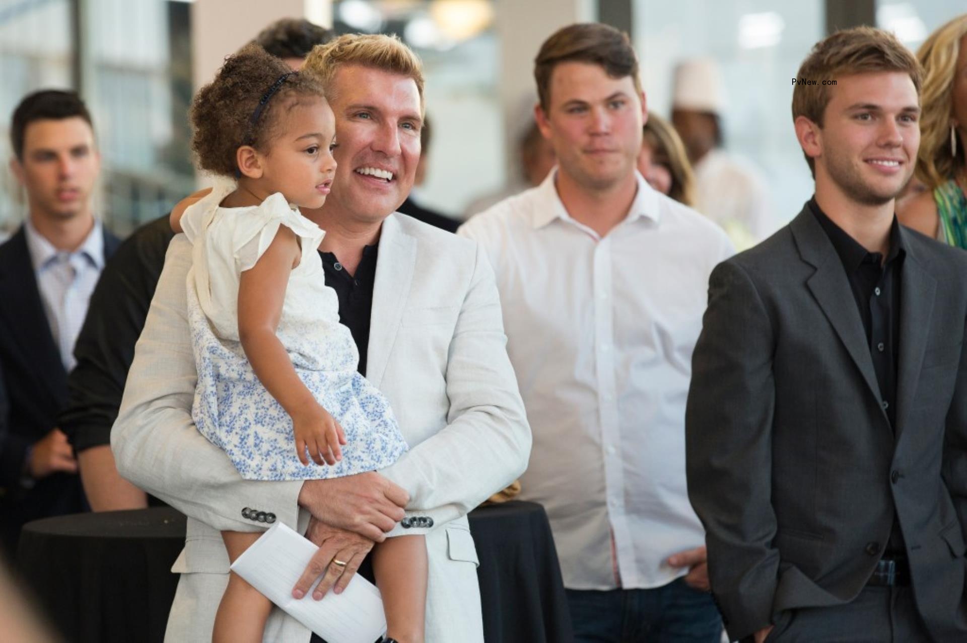 Todd Chrisley carrying his granddaughter Chloe.