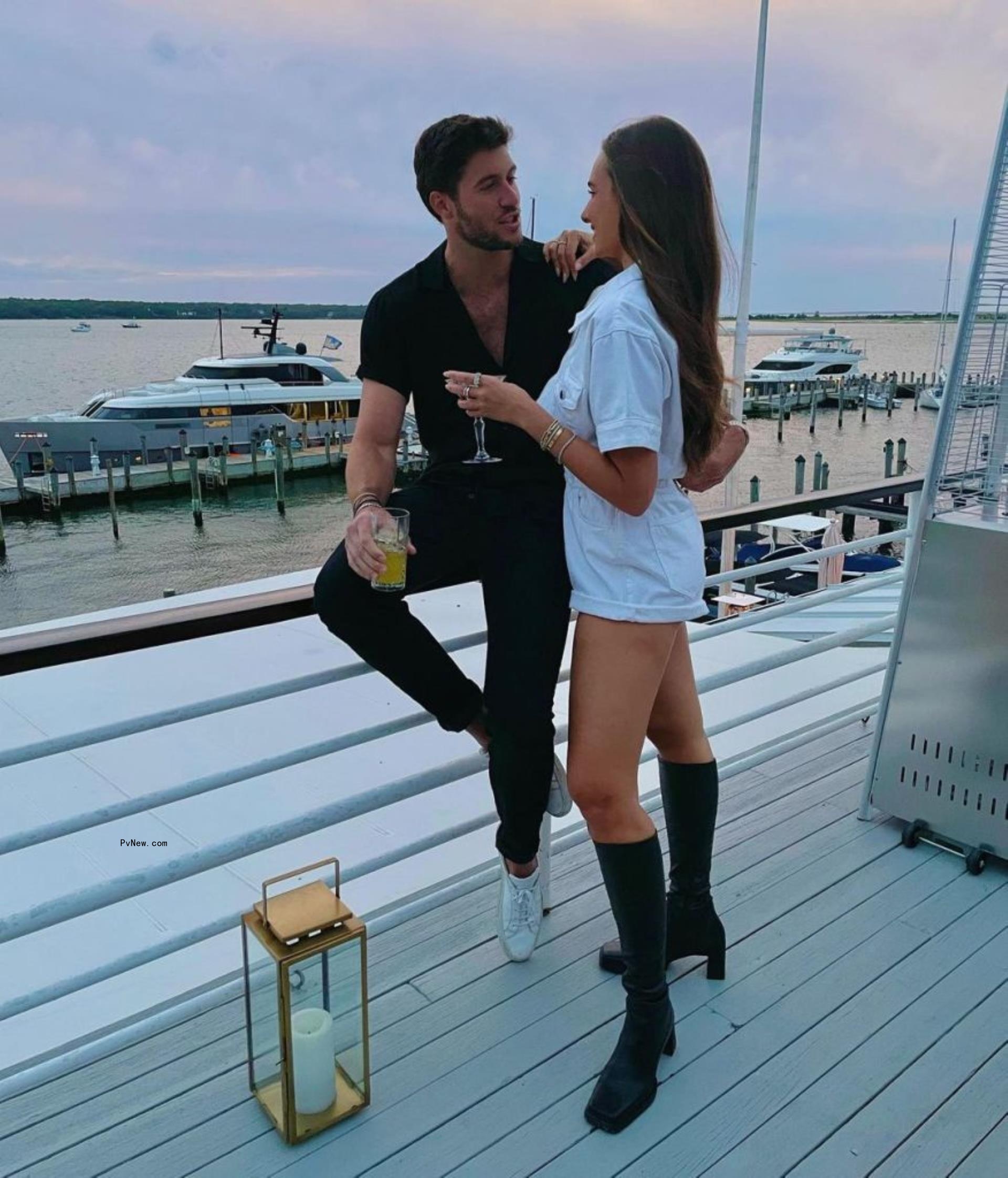 Anthony Adler and Danielle Bernstein in front of a sunset.