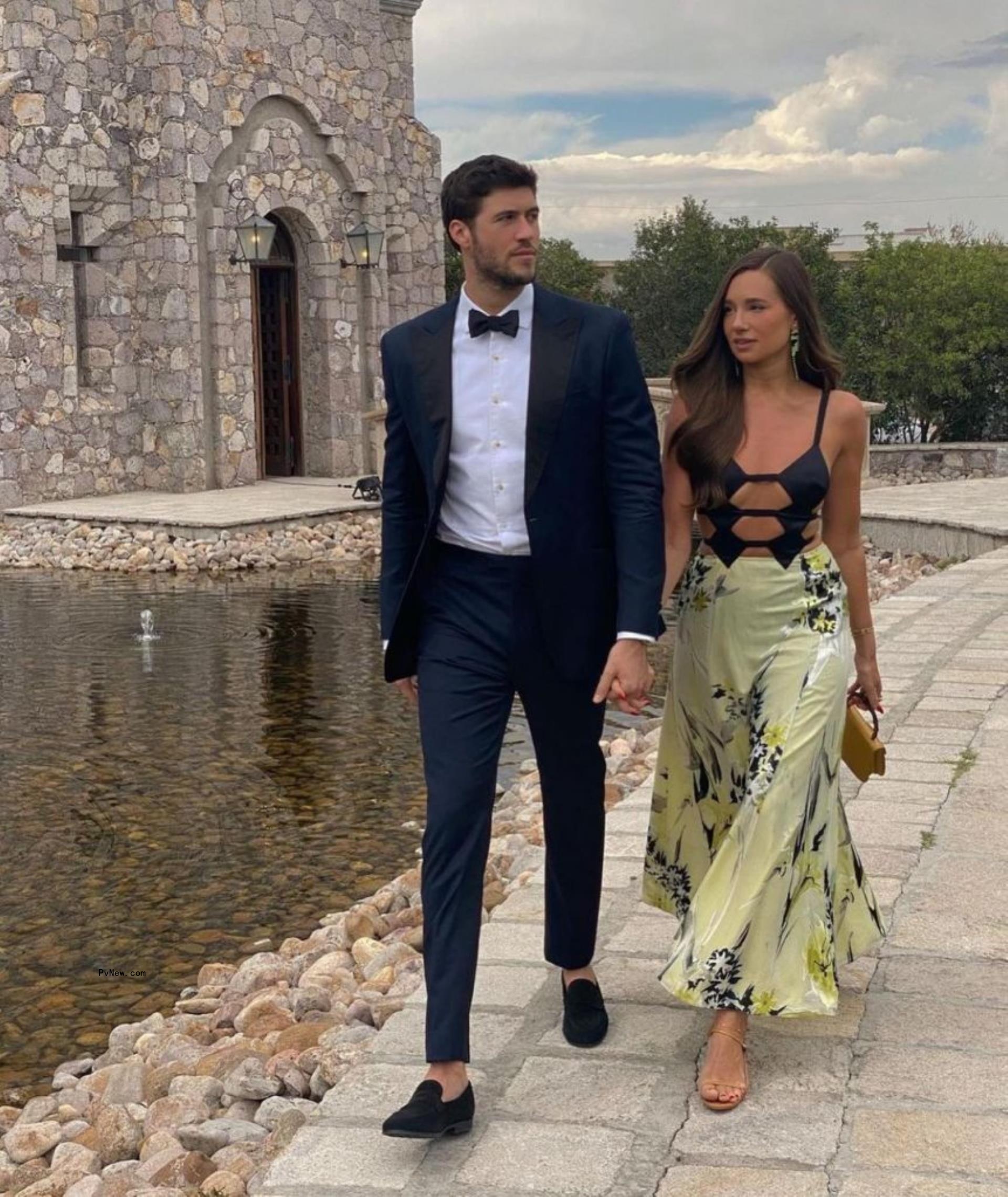 Danielle Bernstein and Anthony Adler holding hands.