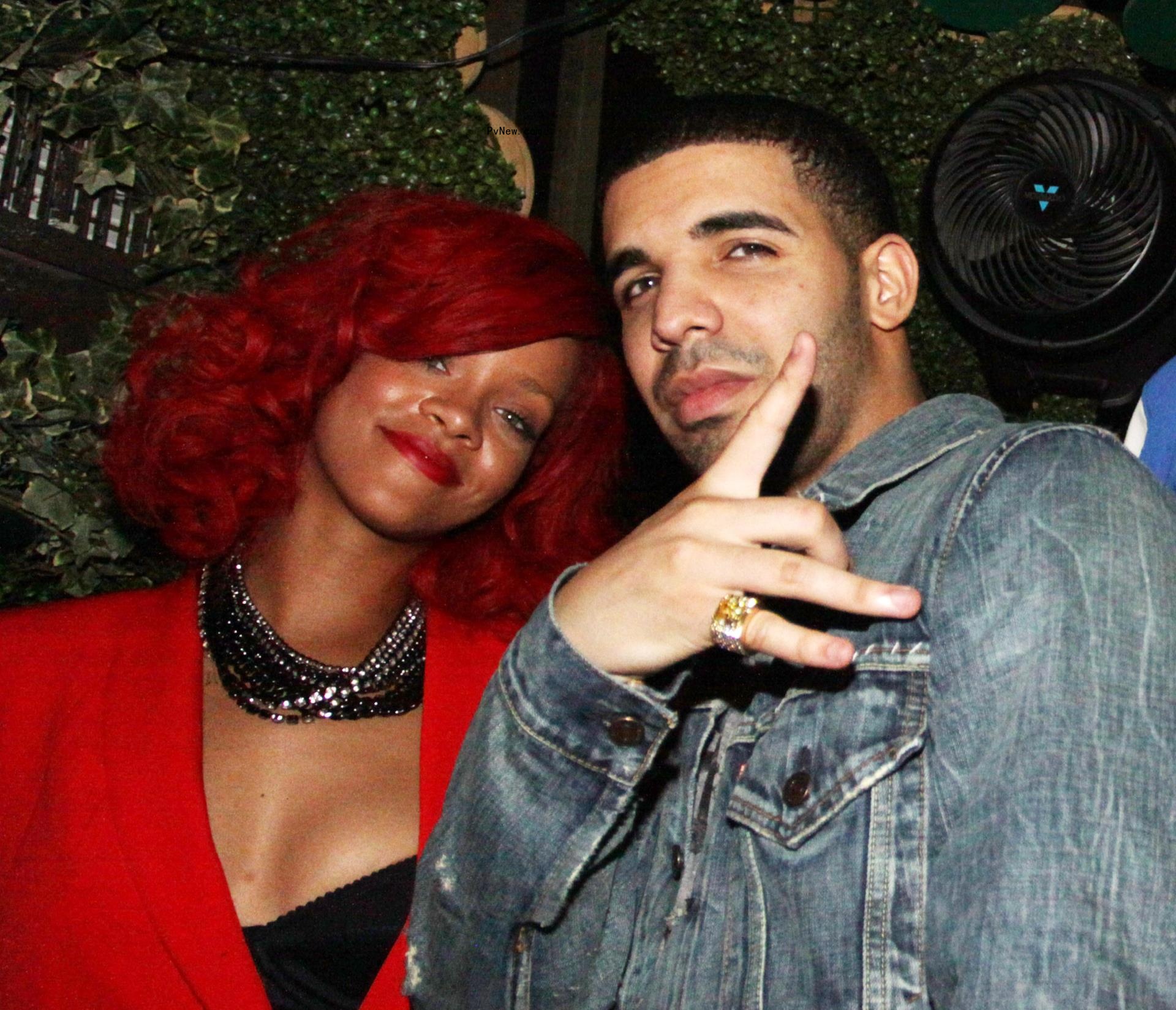 Drake posing with Rihanna.