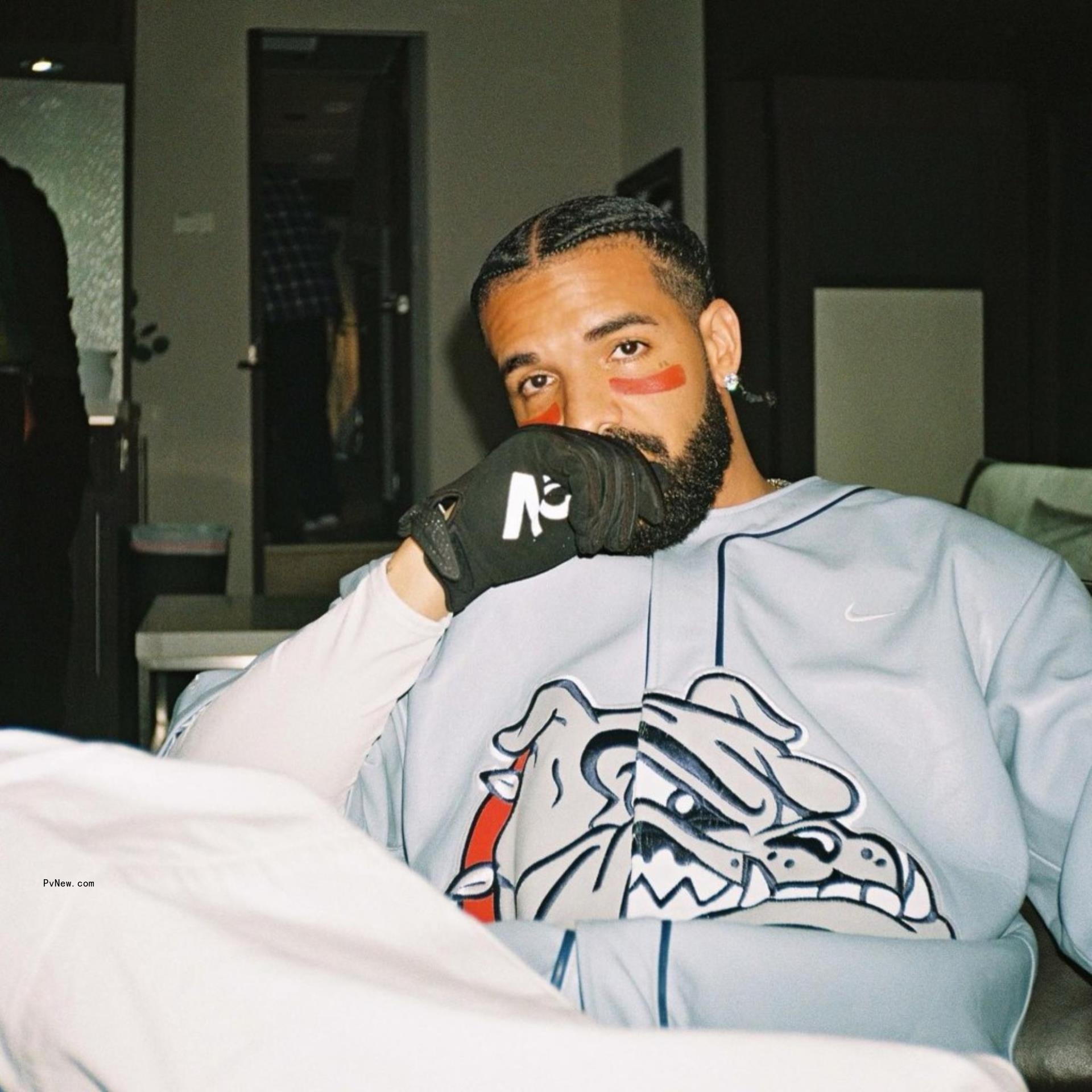 drake with his hand covering his mouth