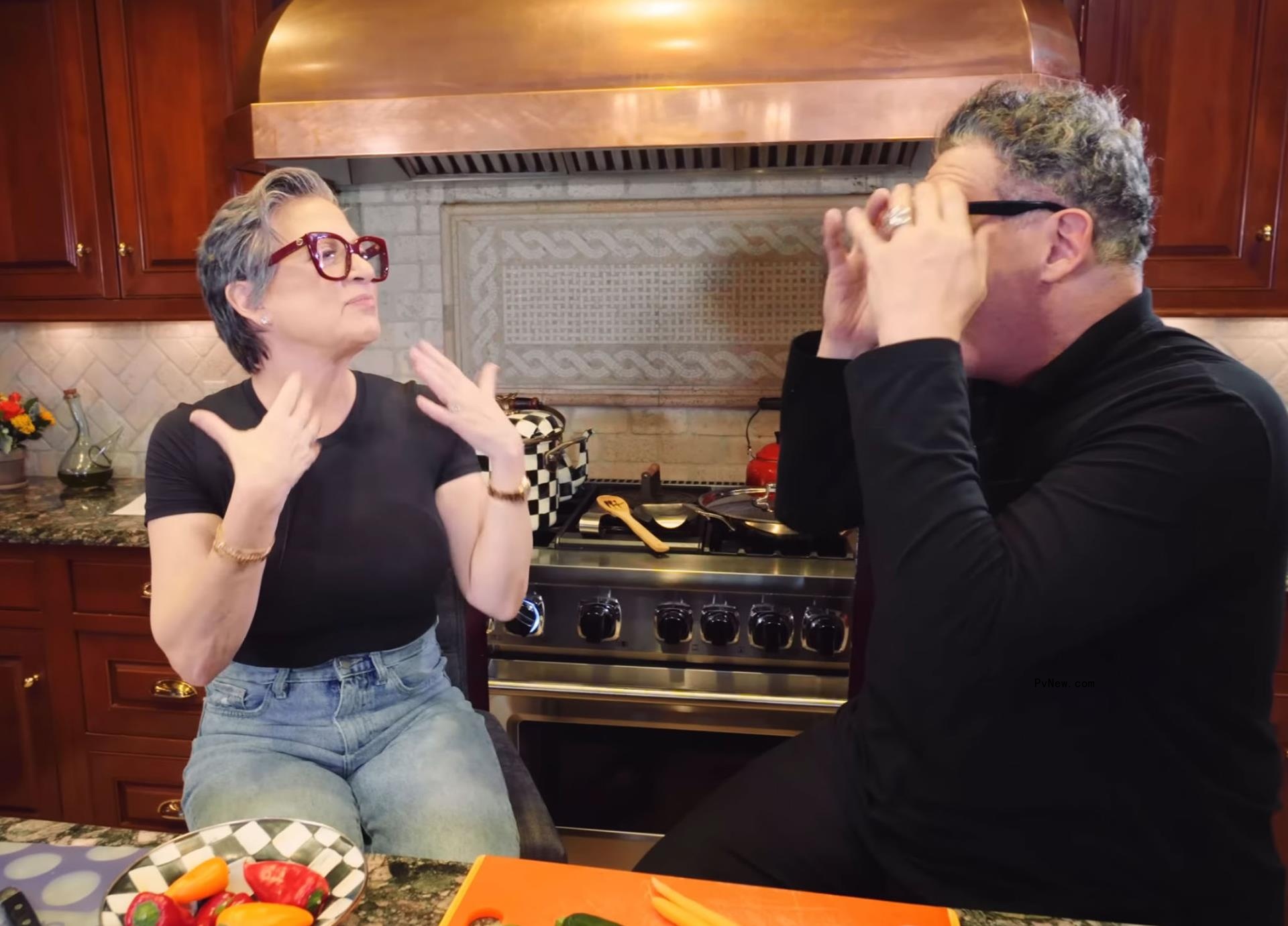 Isaac Mizrahi and Caroline Manzo talking in a kitchen