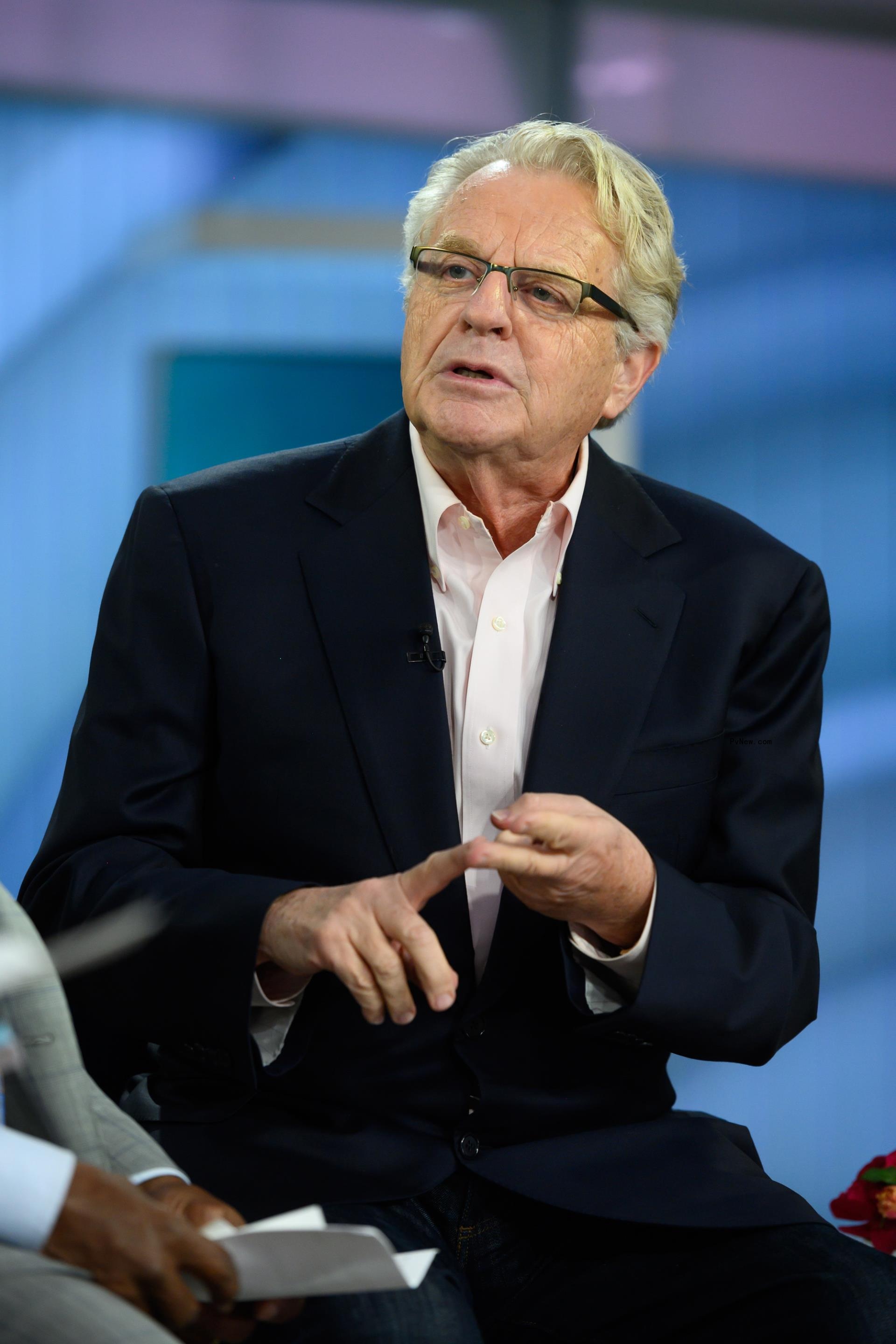 black-and-white photo of jerry springer in front of a crowd