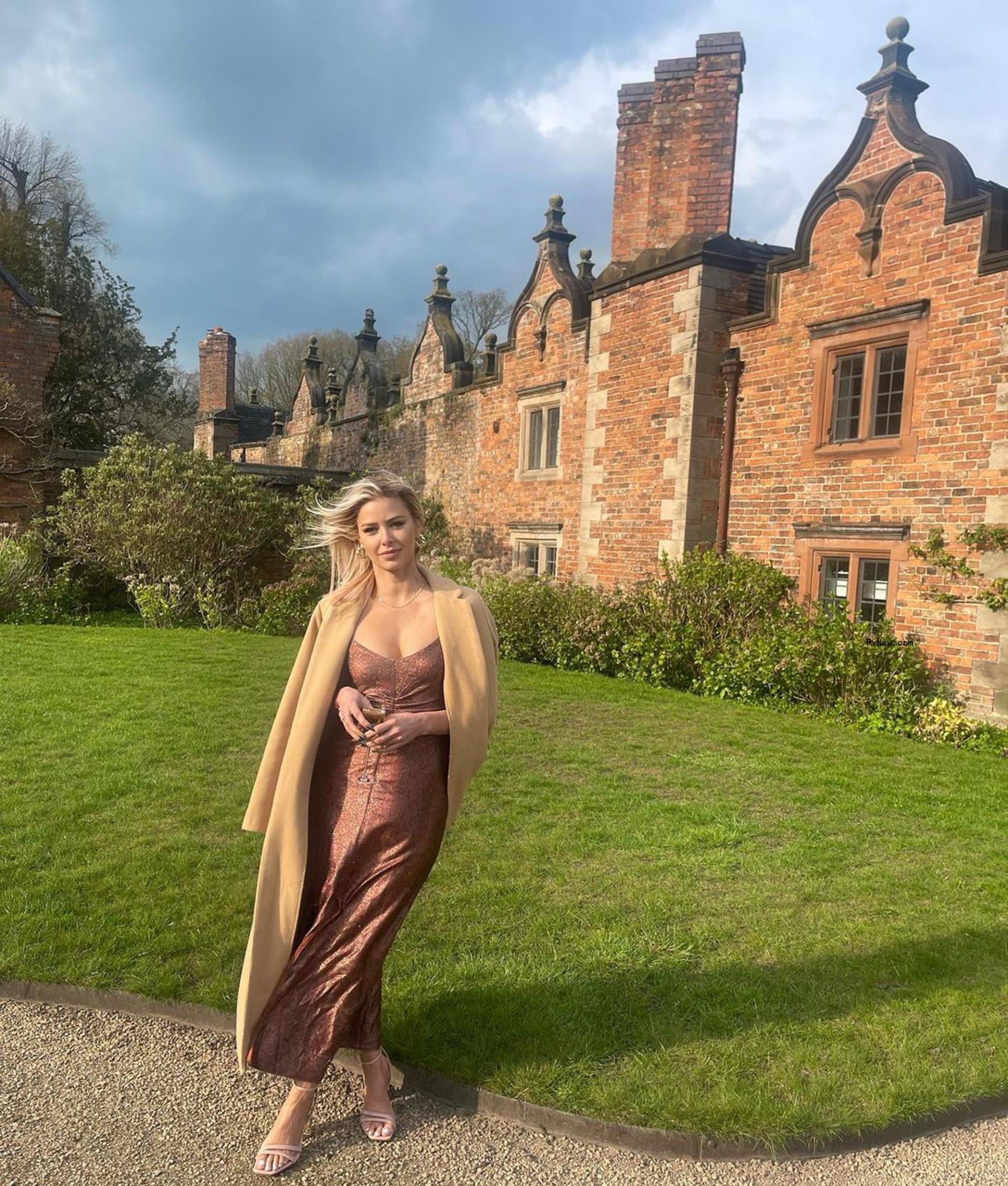 Ariana Madix posing outside of a big house