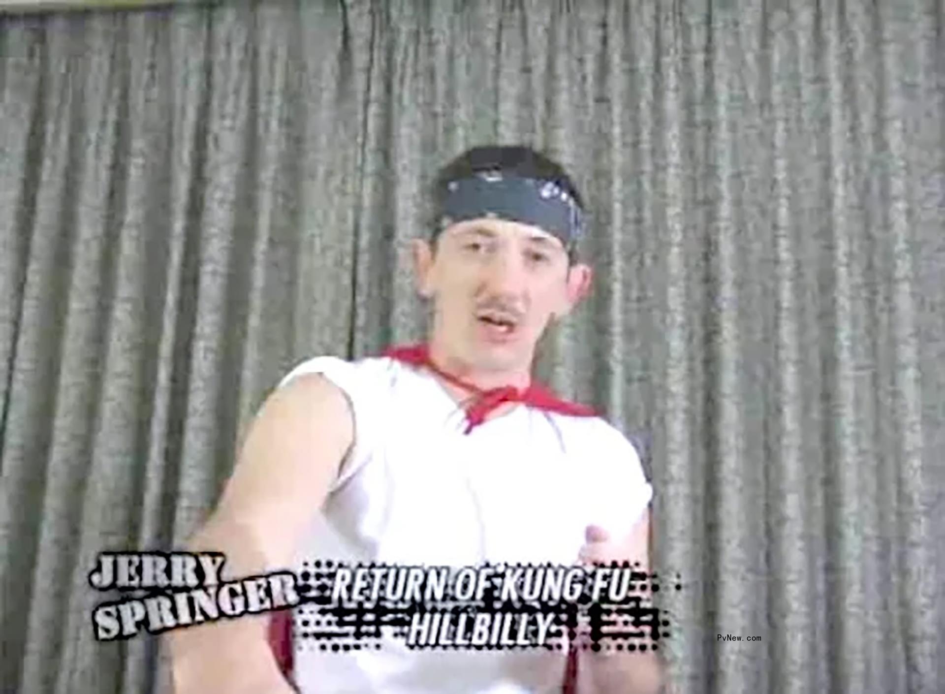 Man wears white tee, cape and bandanna on