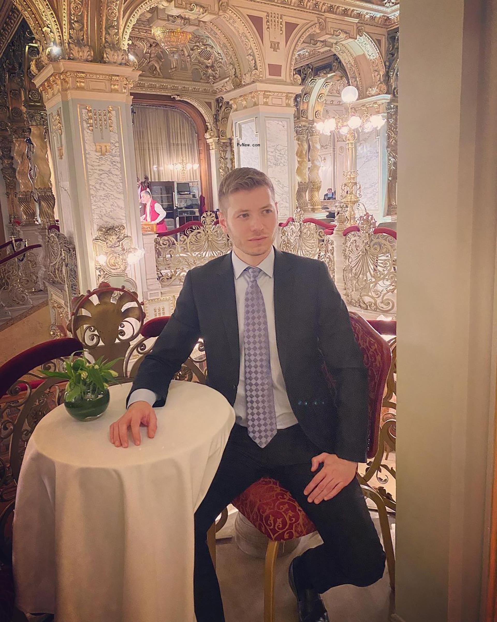 Yair Netanyahu sitting down at a table while in a suit.