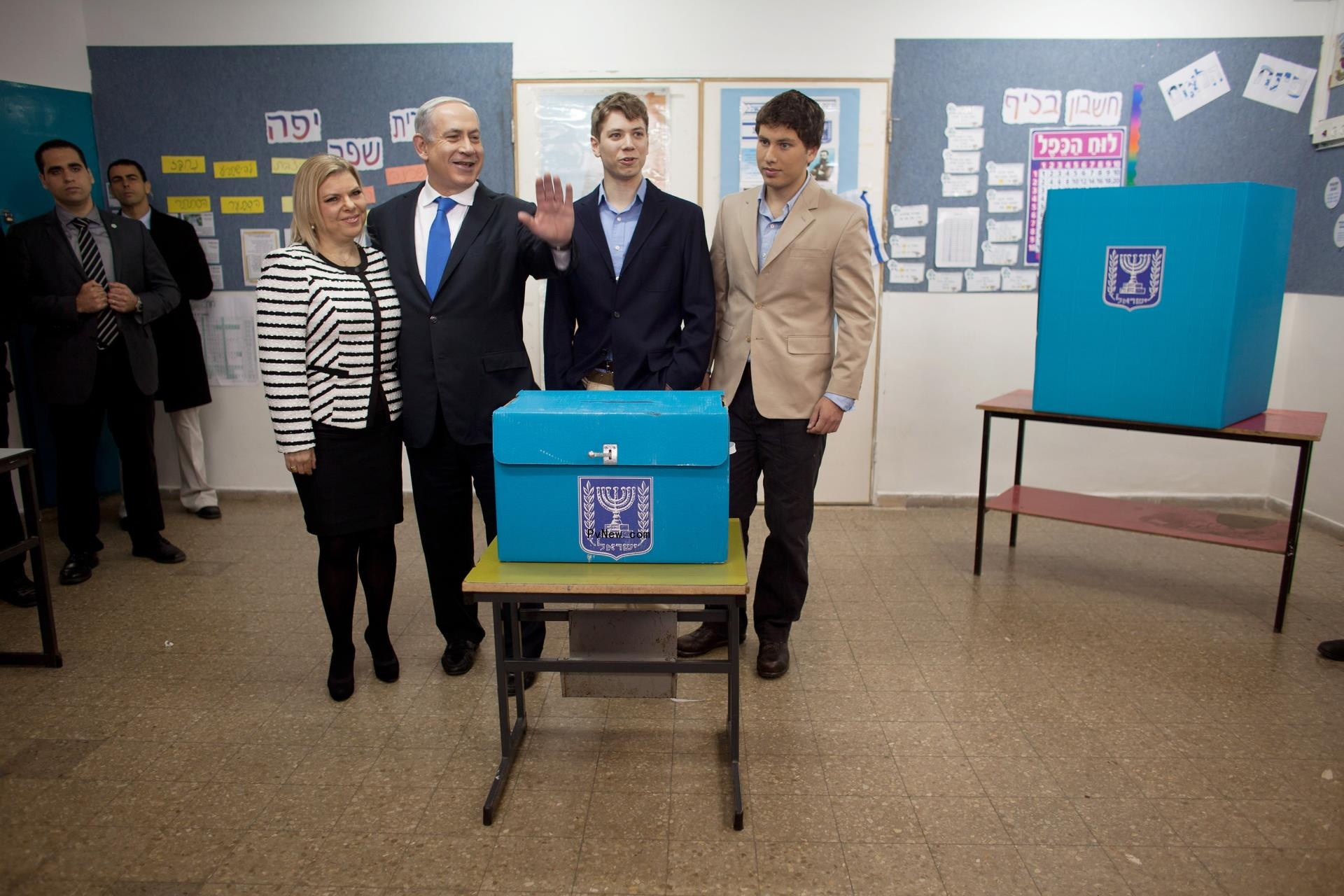 Benjamin Netanyahu, his wife Sara Netanyahu and sons Yair Netanyahu and Avner Netanyahu posing for a photo together at a polling station.