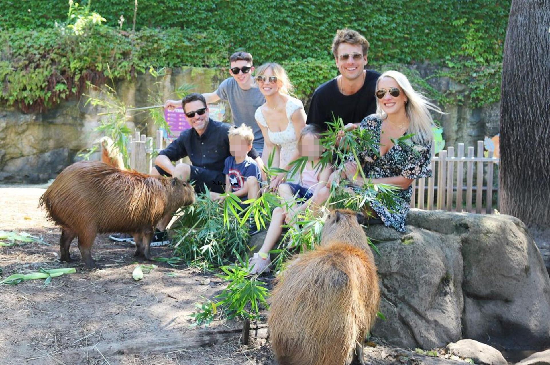 Glen Powell and his family with Sydney Sweeney at the zoo.