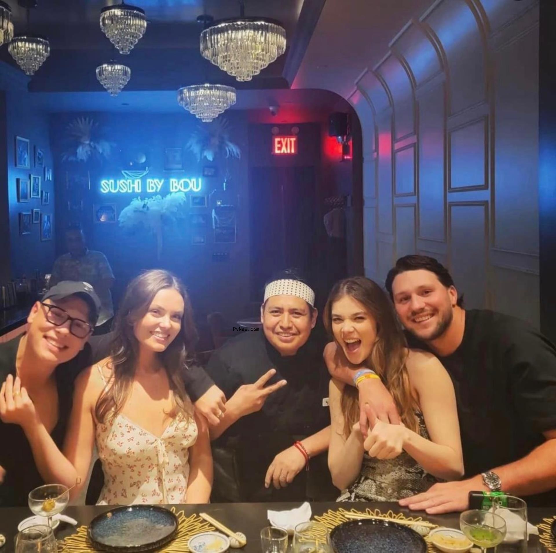 hailee steinfeld, josh allen and two friends posing with a sushi chef