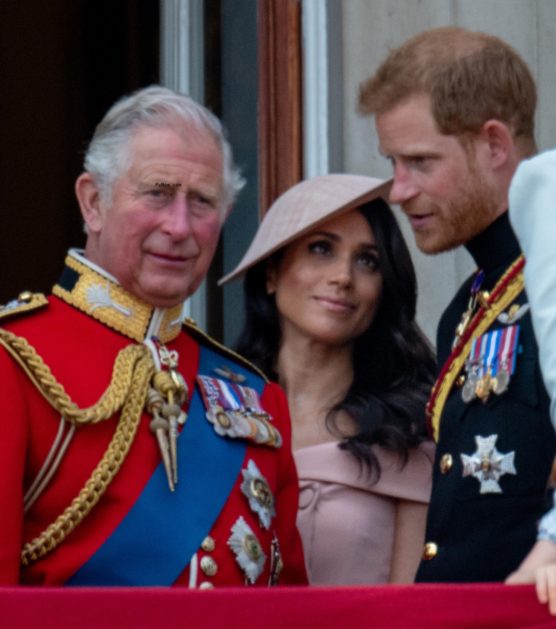 Charles with Prince Harry and his wife Meghan Markle