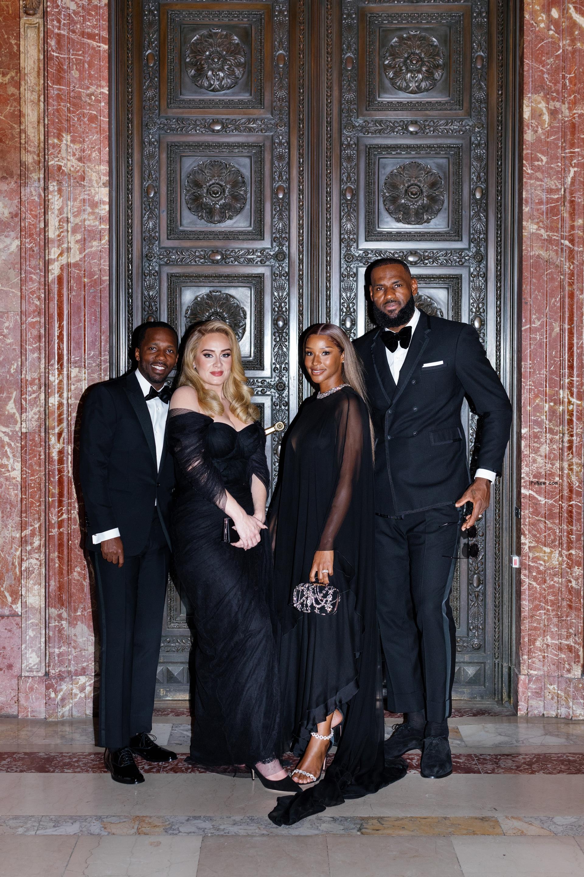 Rich Paul and Adele posing with Lebron James and his wife.