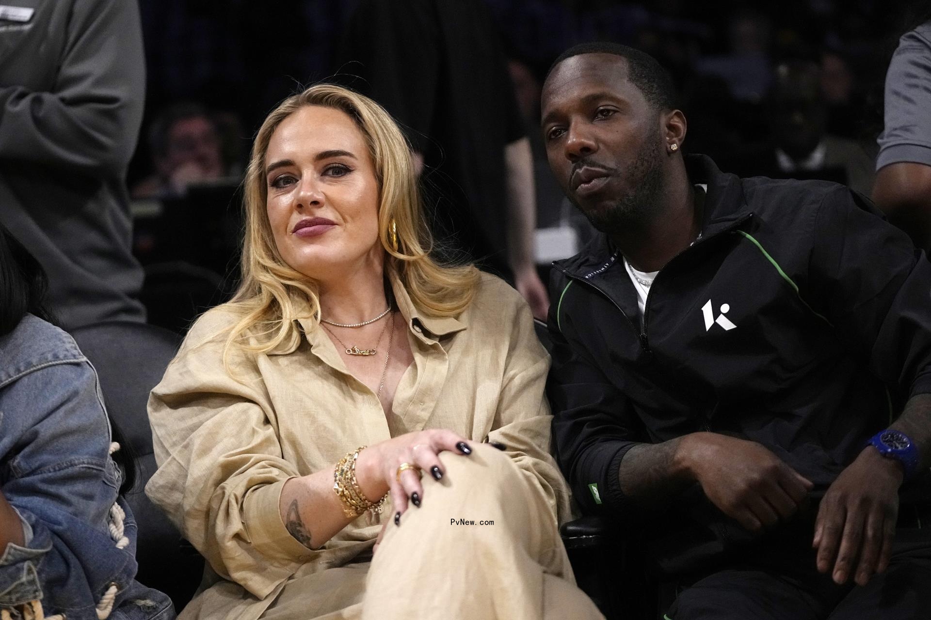 Rich Paul and Adele sitting courtside.