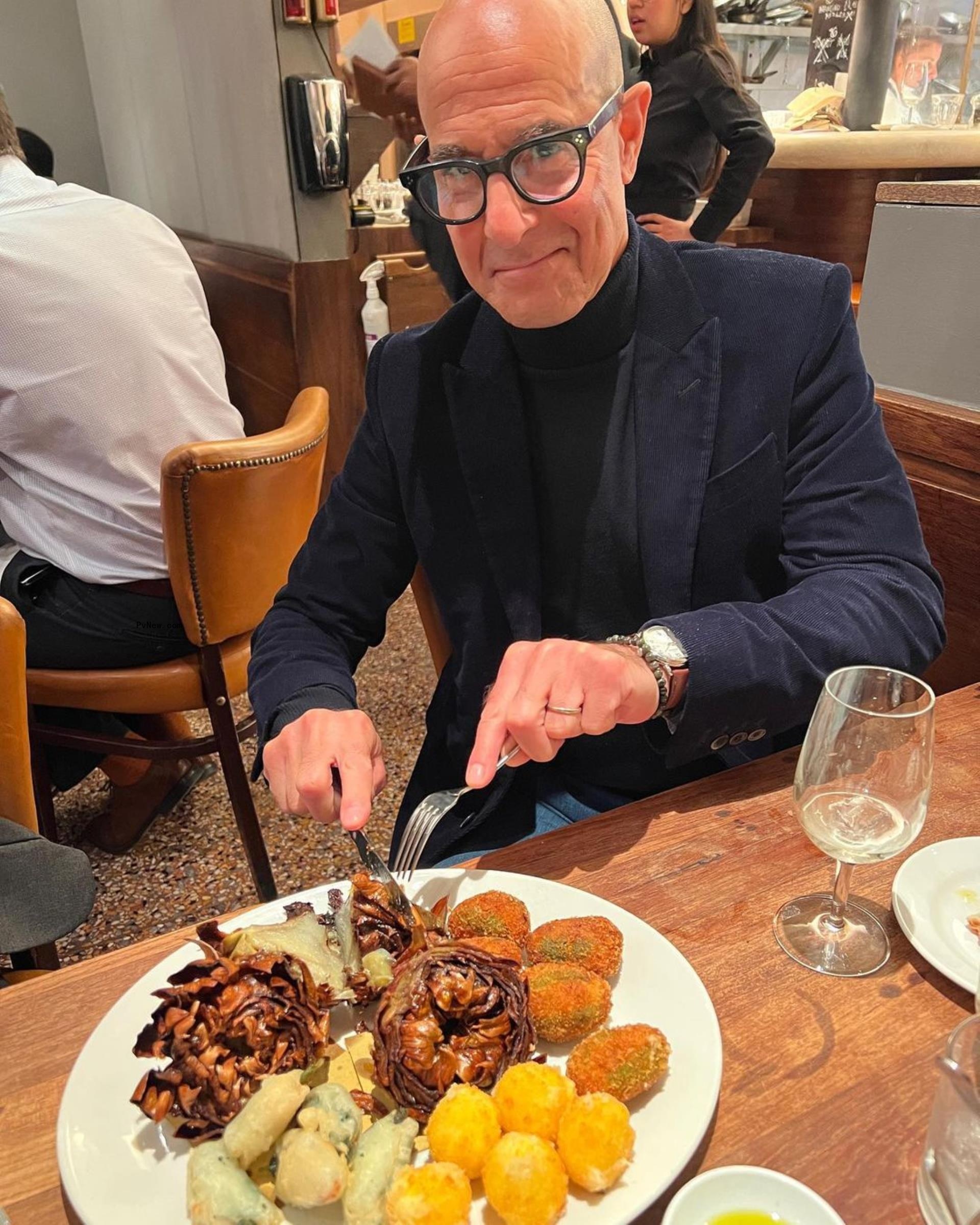 stanley tucci cutting into a plate of food