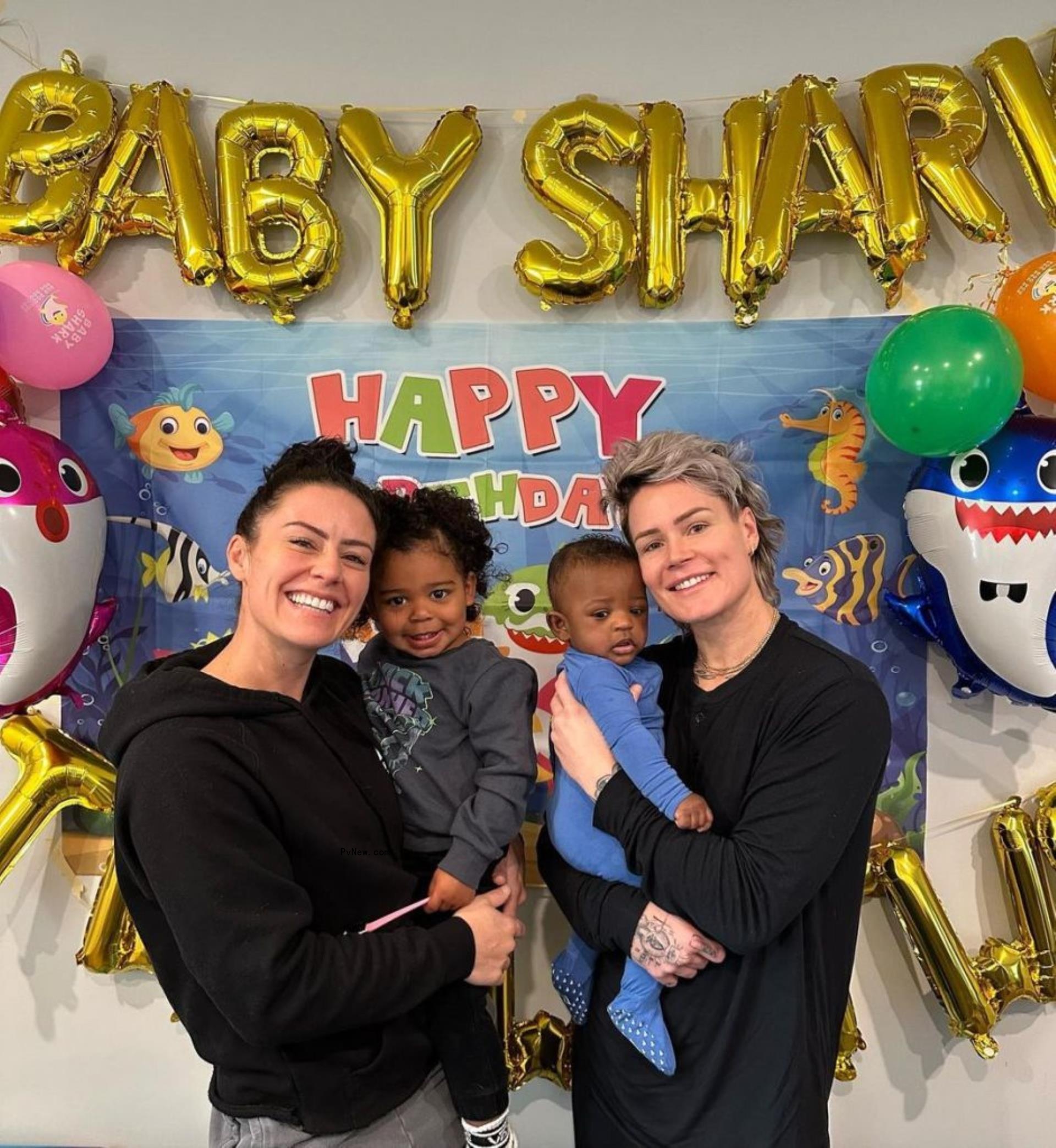 ashlyn harris and ali krieger holding their two children