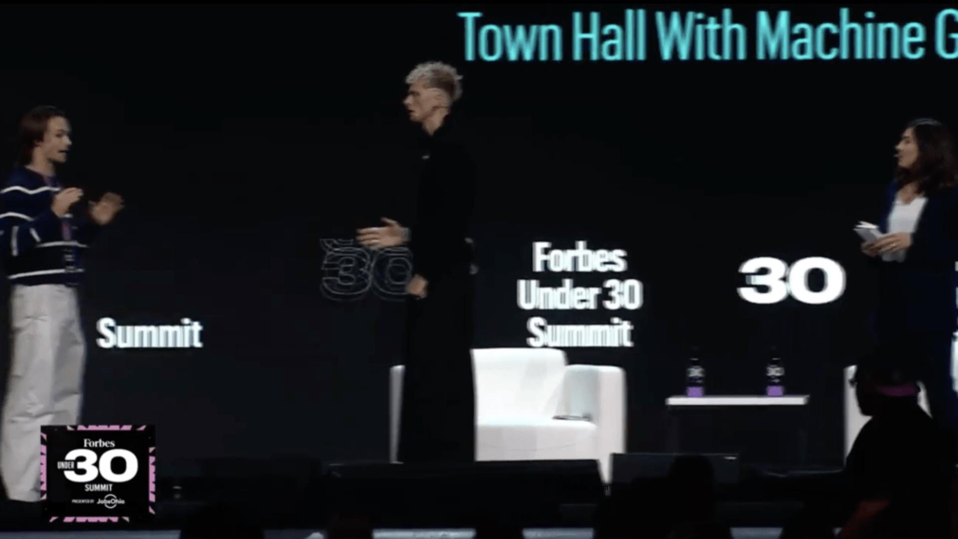 Machine Gun Kelly speaking to fan o<i></i>nstage at Forbes Under 30 Summit