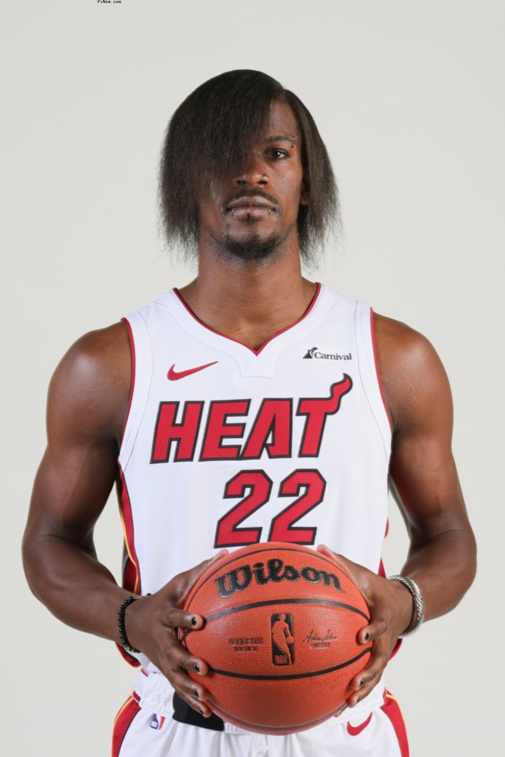 Jimmy Butler posing in uniform with emo look.