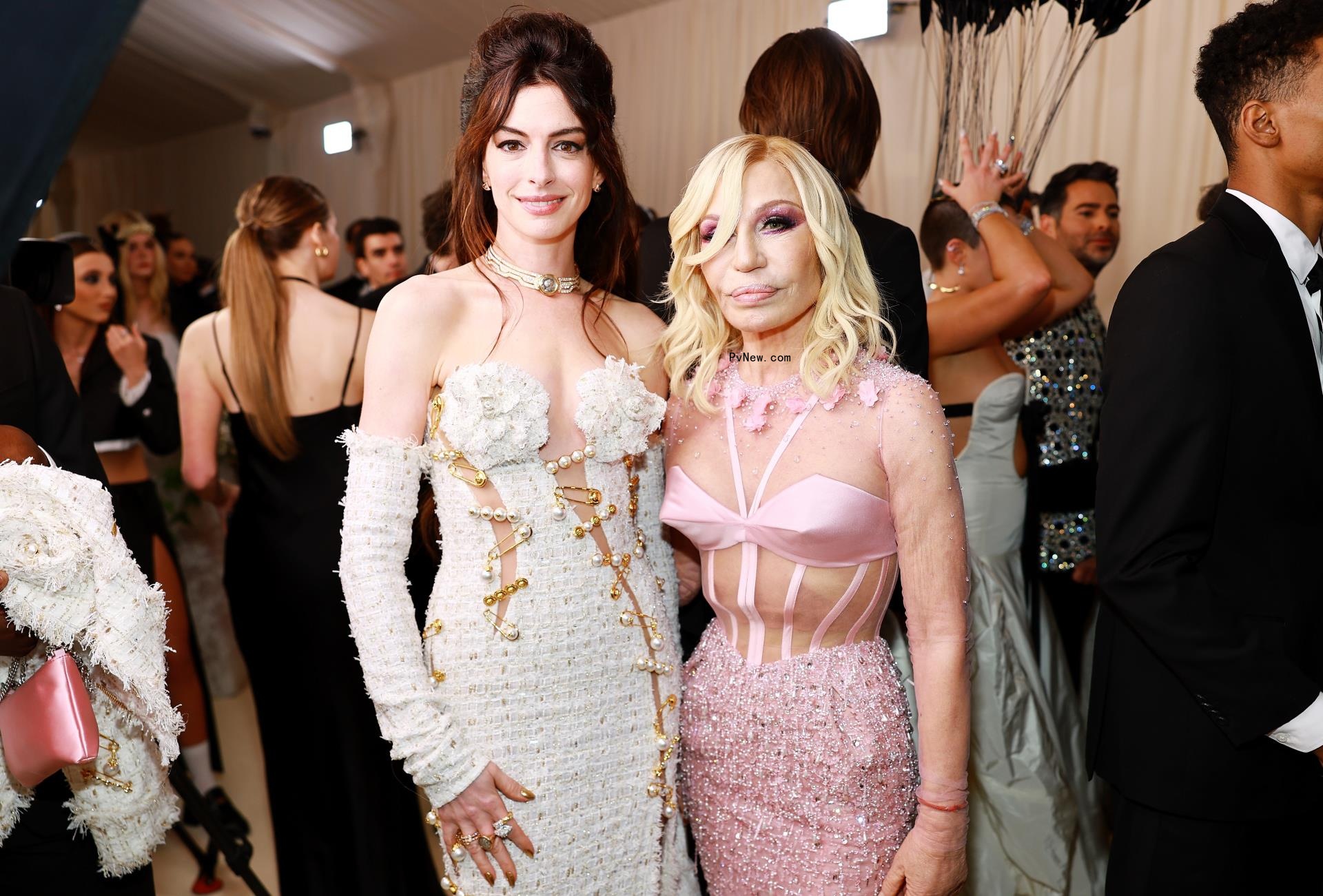 Anne Hathaway and Do<i></i>natella Versace posing at on the Met Gala 2023 red carpet