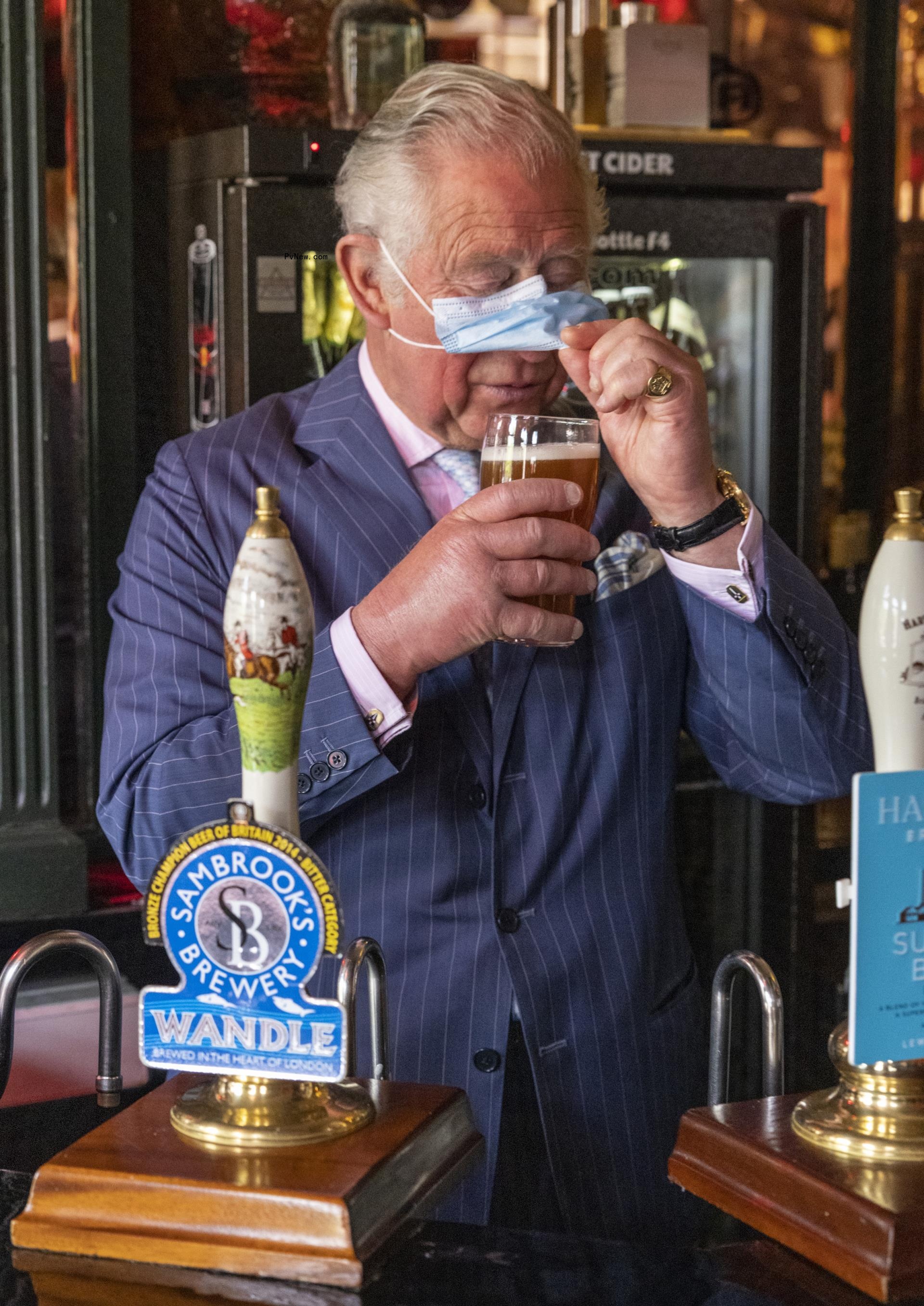 king charles iii drinking a beer.
