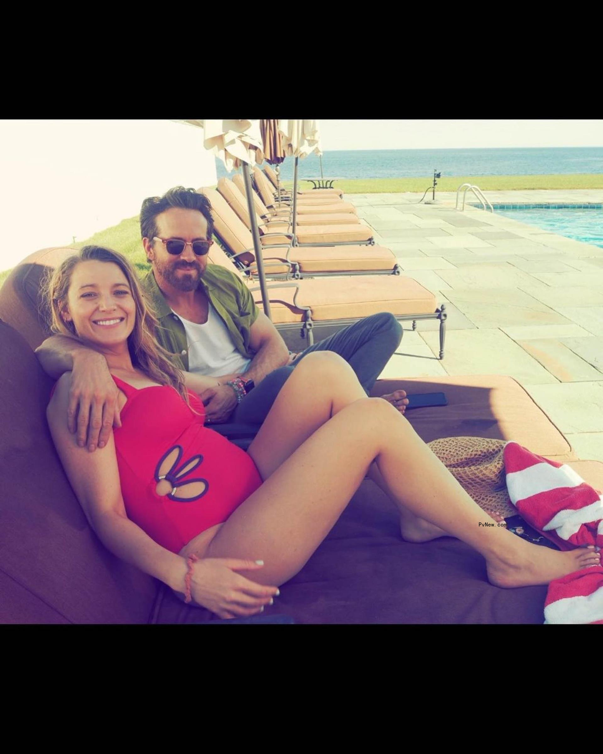 Blake Lively wears bathing suit sitting with Ryan Reynolds by pool