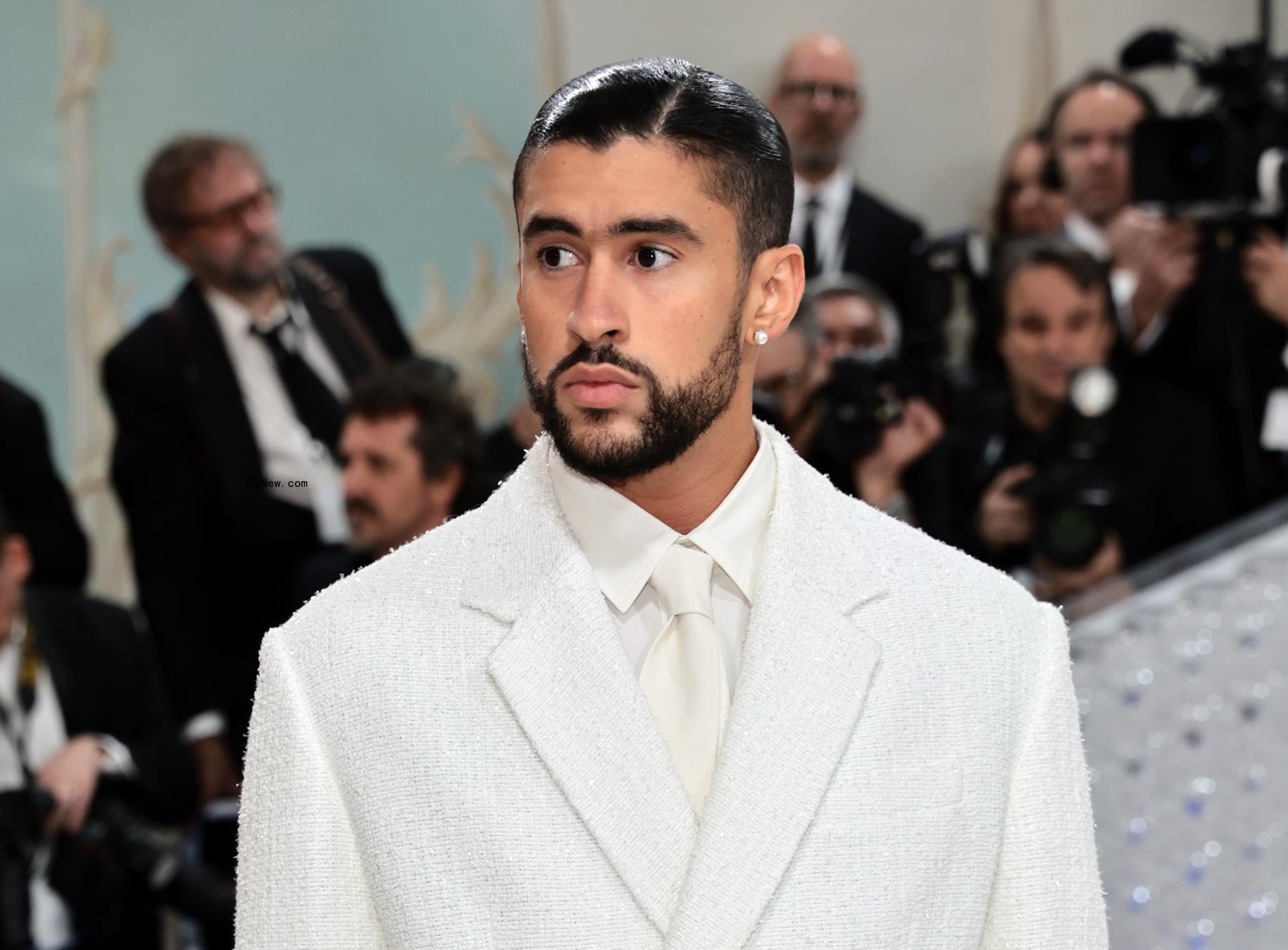 Bad Bunny posing at the 2023 Met Gala red carpet.