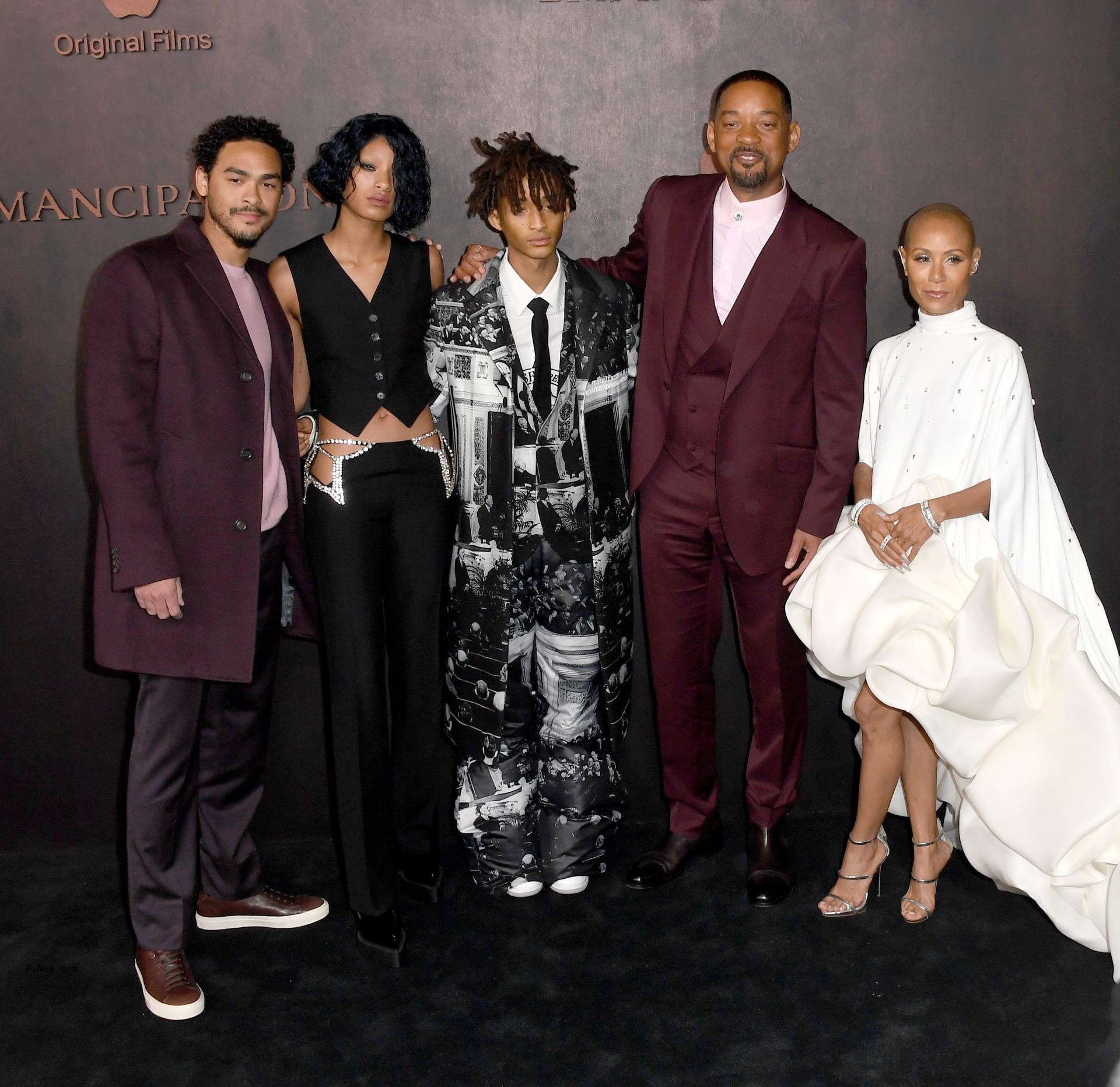 Jada Pinkett Smith and Will Smith with their three kids at a red carpet event.