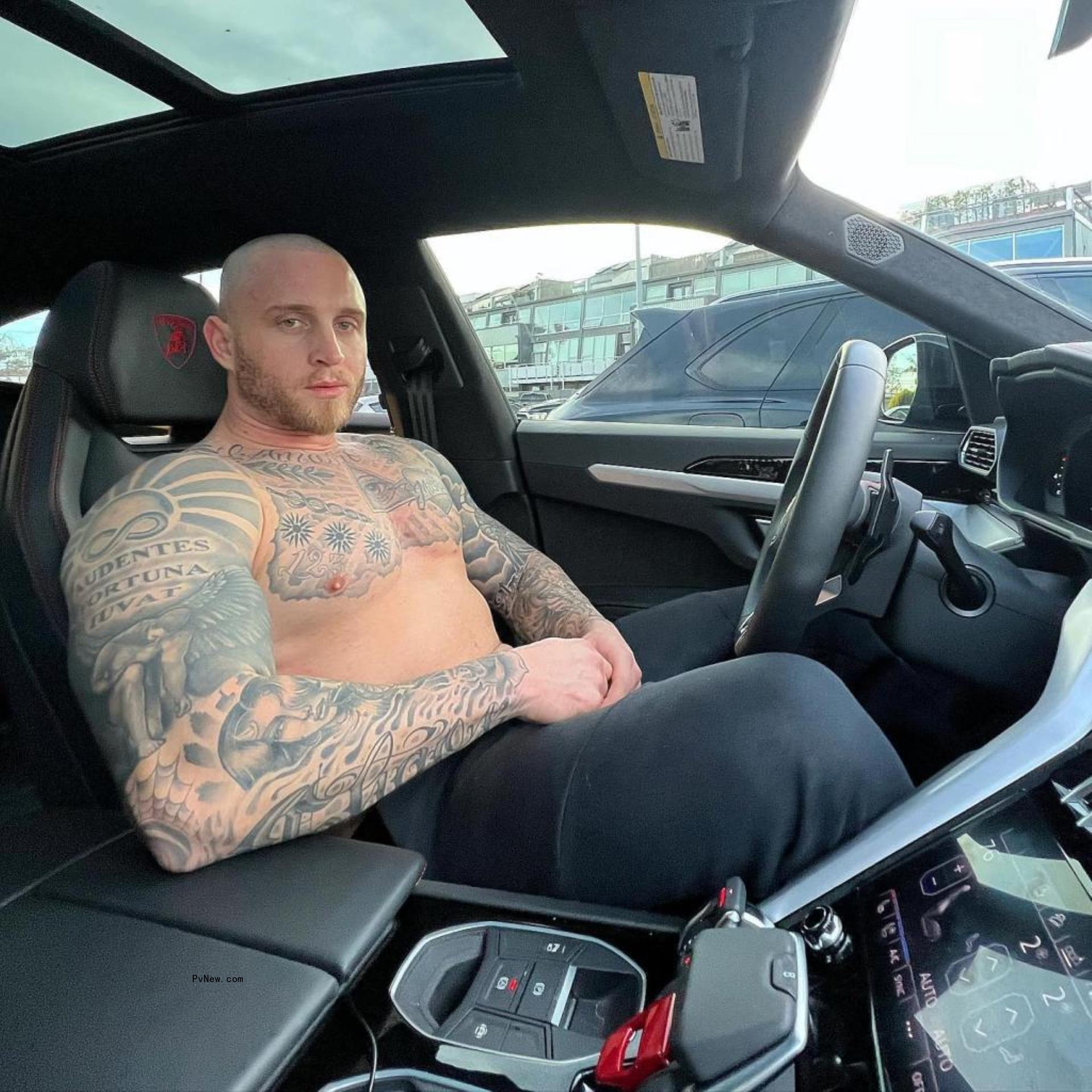 shirtless chet hanks sitting in the driver's seat of a car