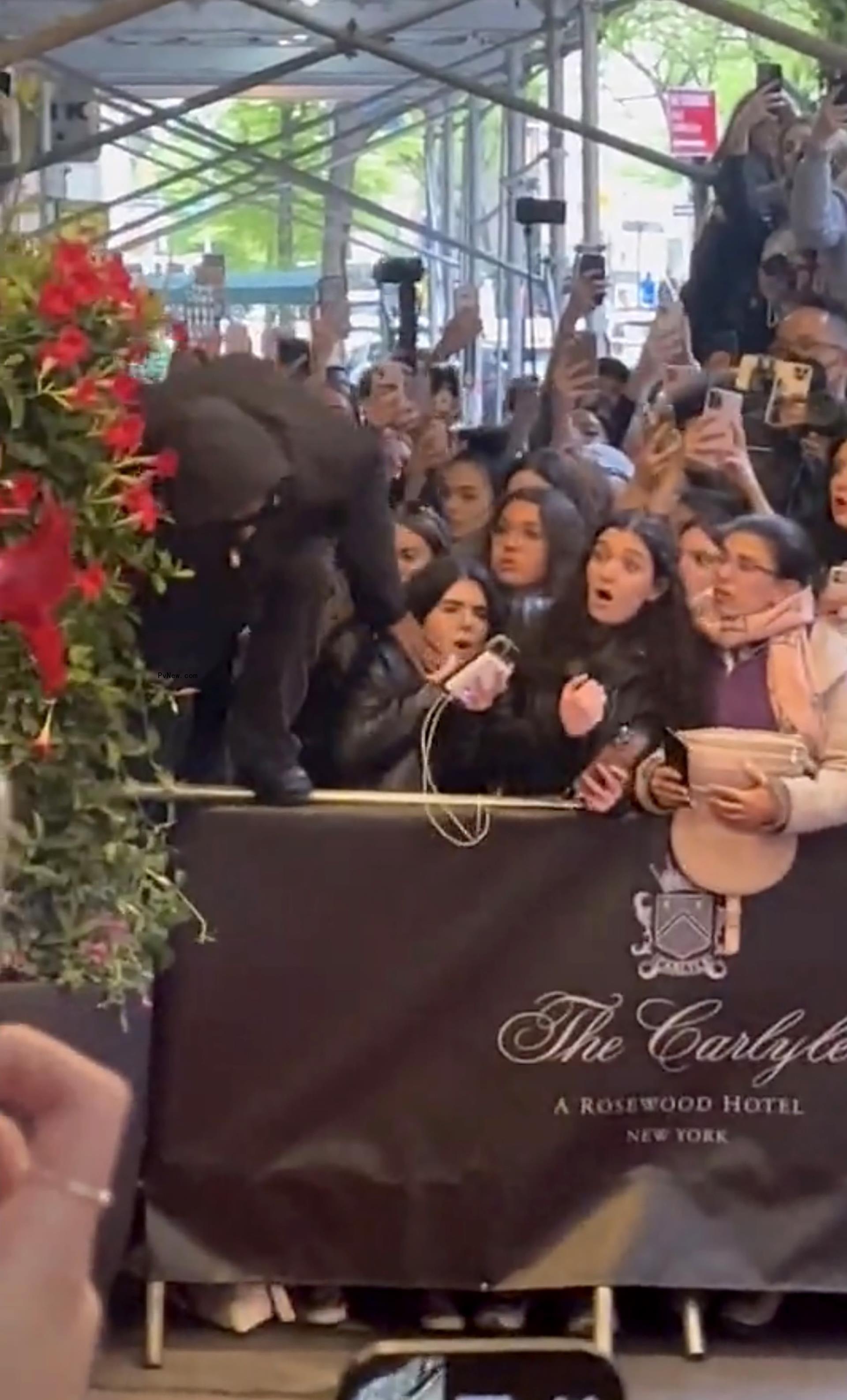A$AP Rocky jumping over a barricade.