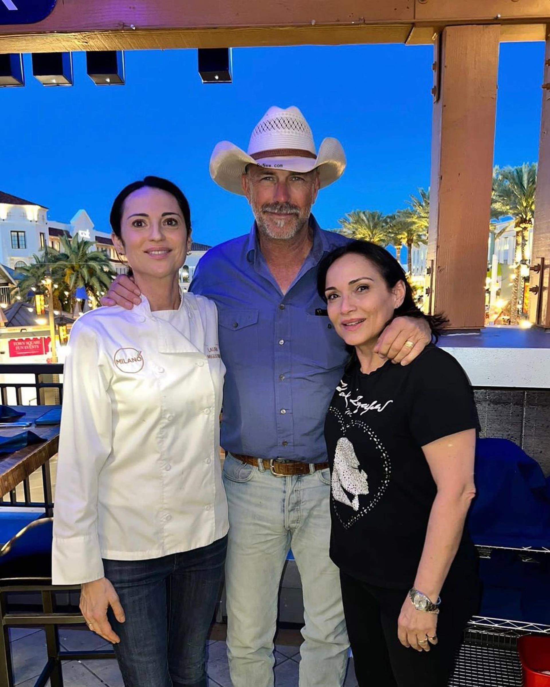 Kevin Costner posing for a photo with two women
