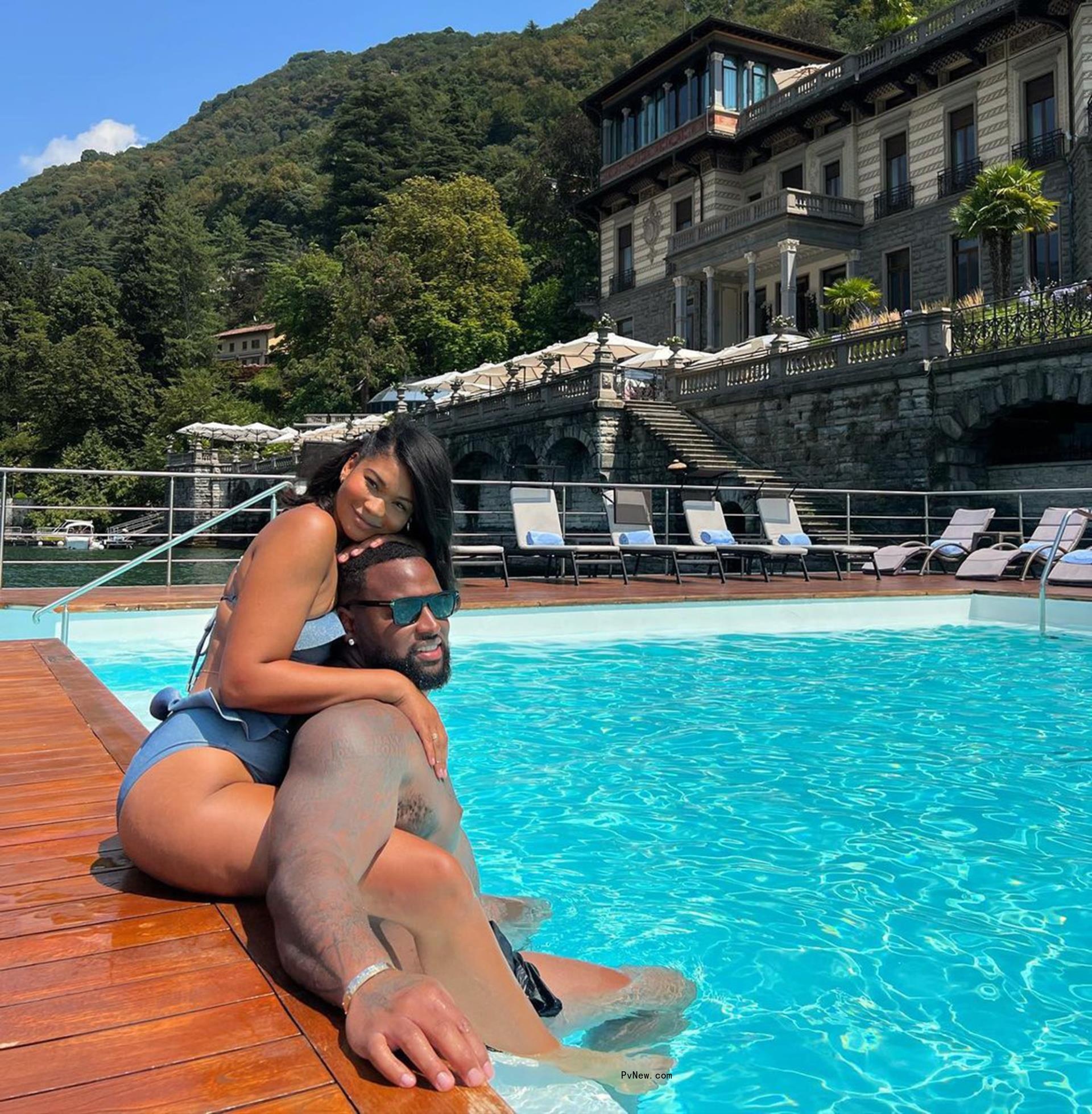 Chanel Iman cuddles with Davon Godchaux at the pool