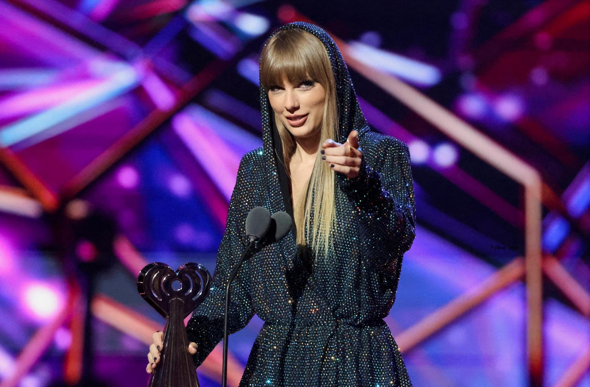 Taylor Swift accepting an award onstage.