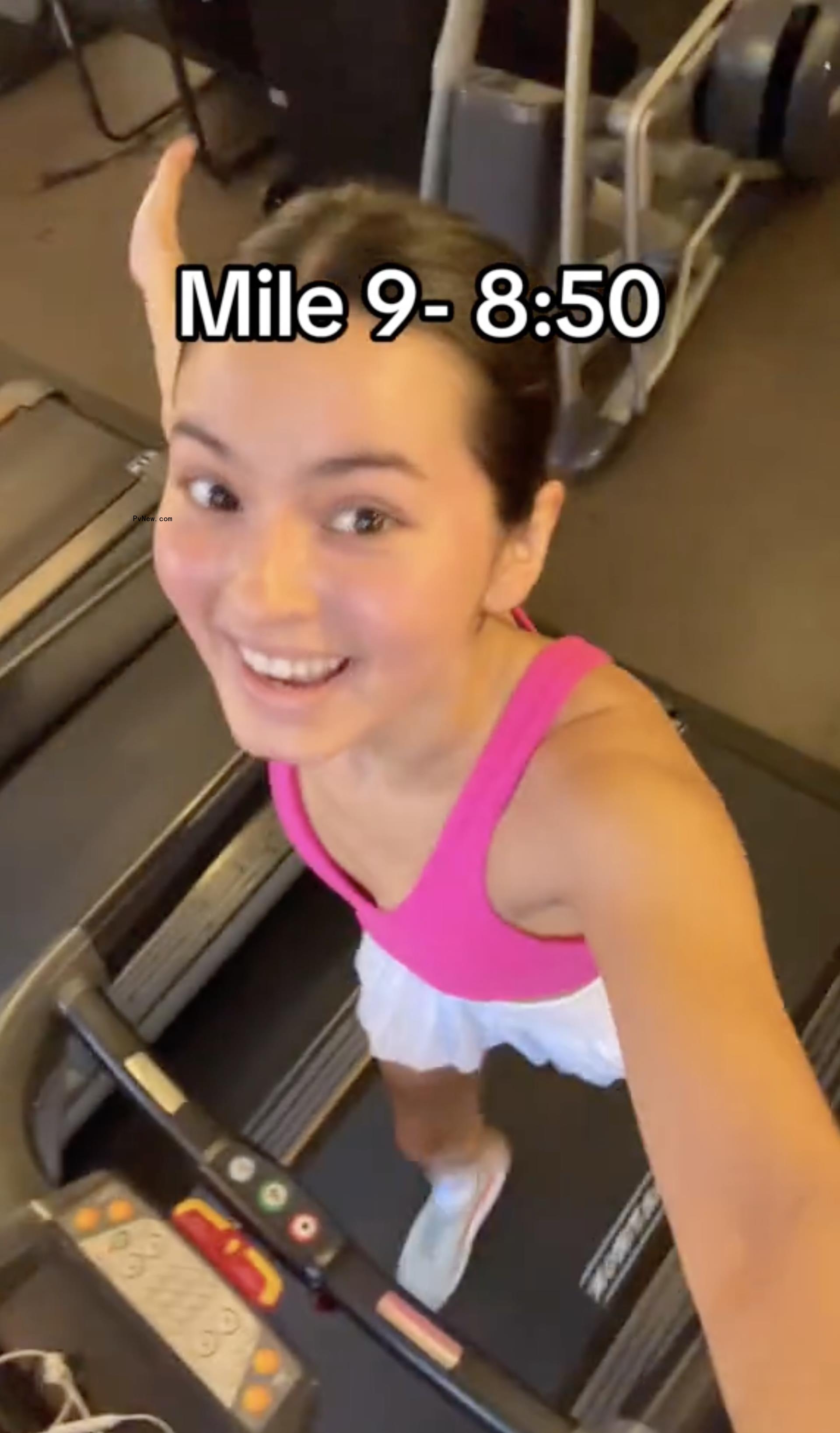 Woman in pink shirt on treadmill.