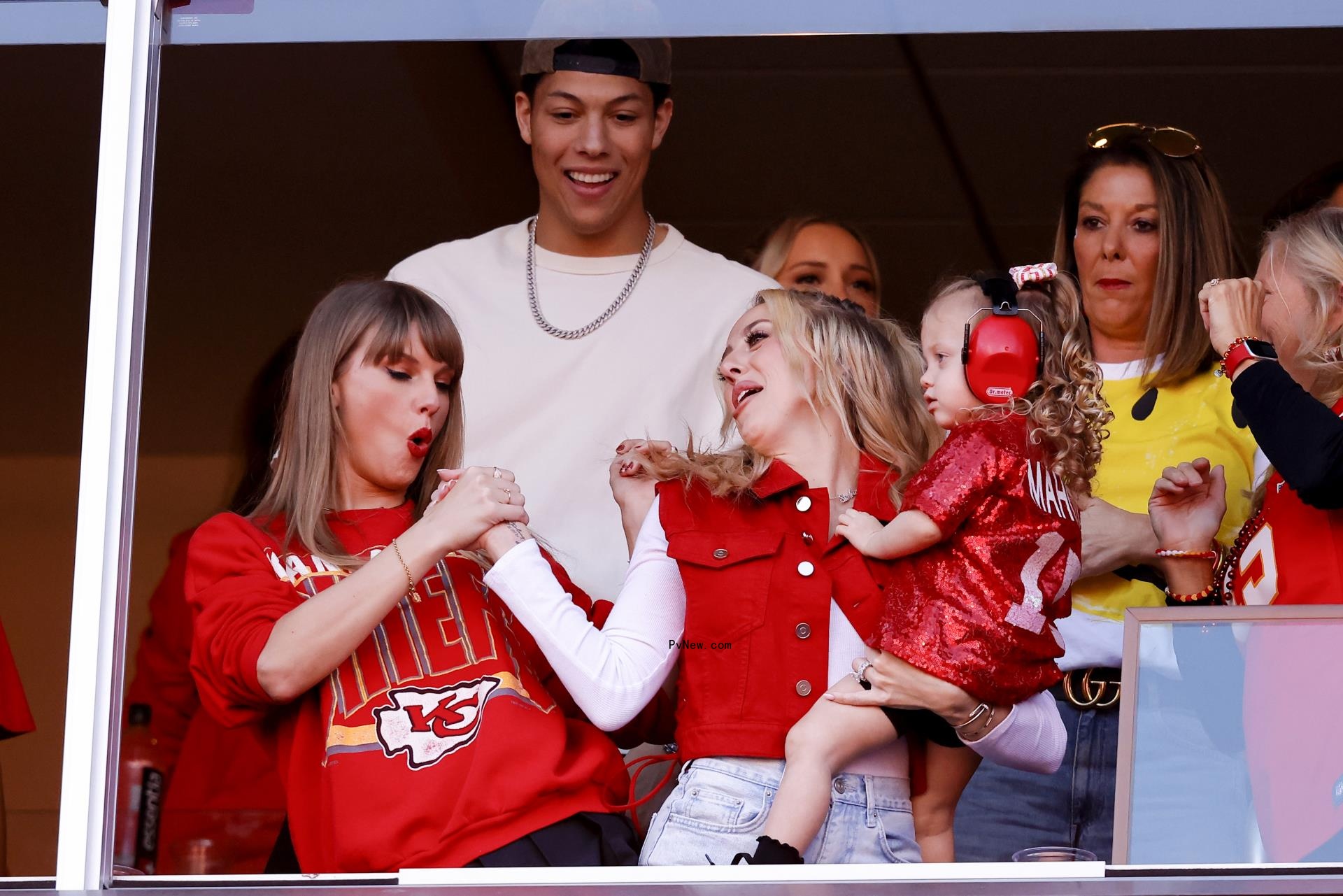 Taylor Swift doing a handshake with Brittany Mahomes.