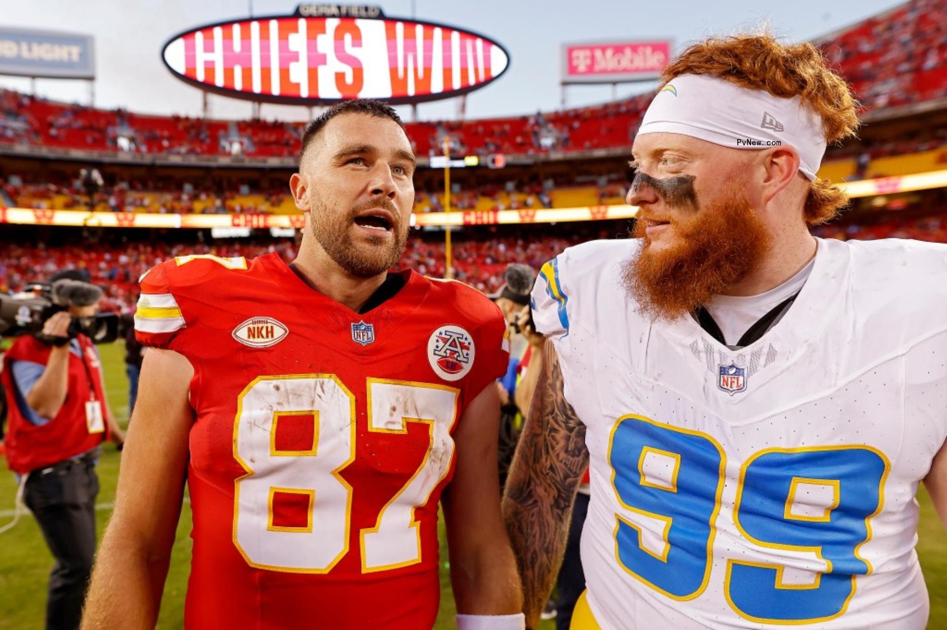 Travis Kelce and Scott Matlock on football field