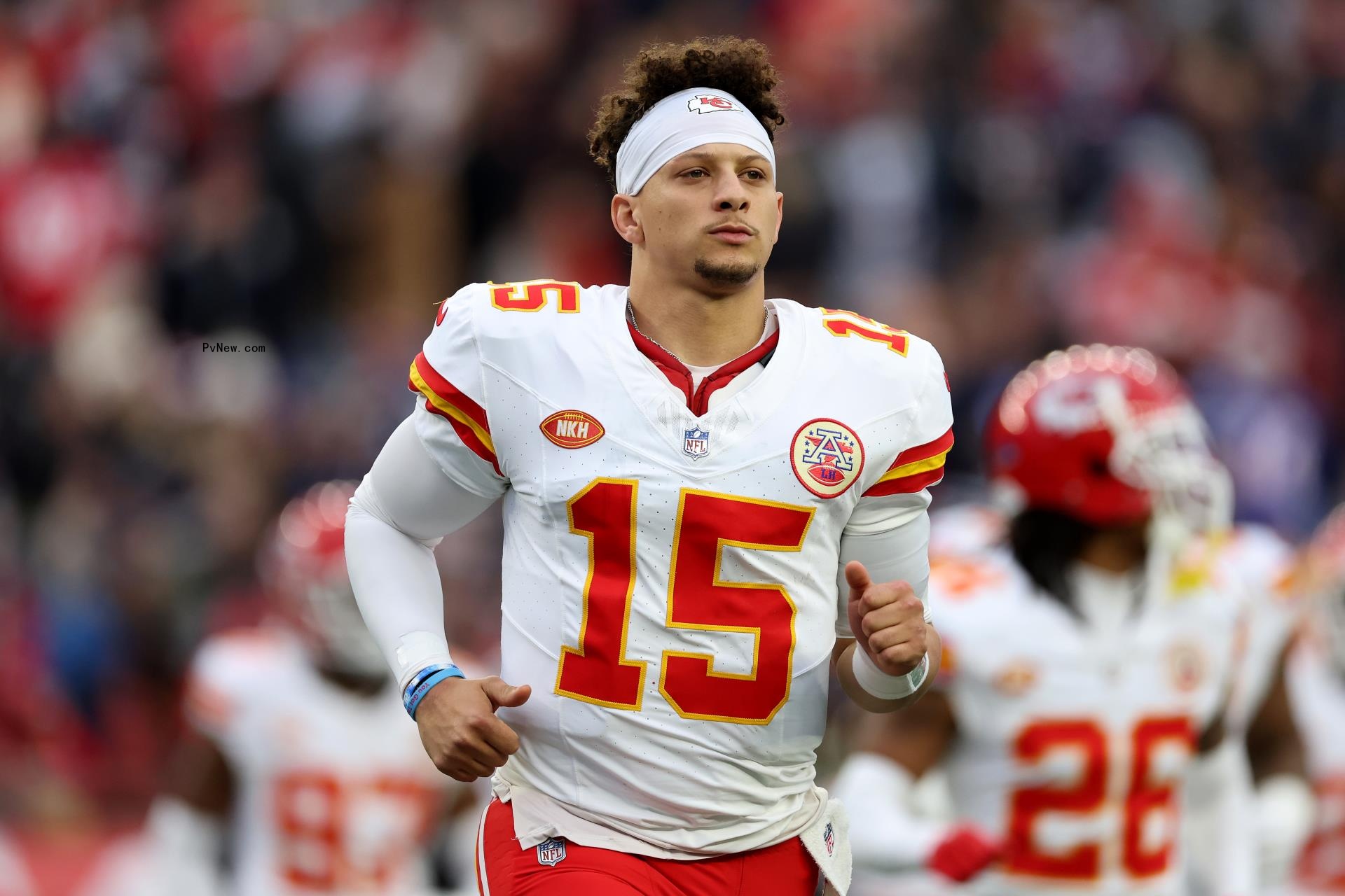 Patrick Mahomes running in his uniform.