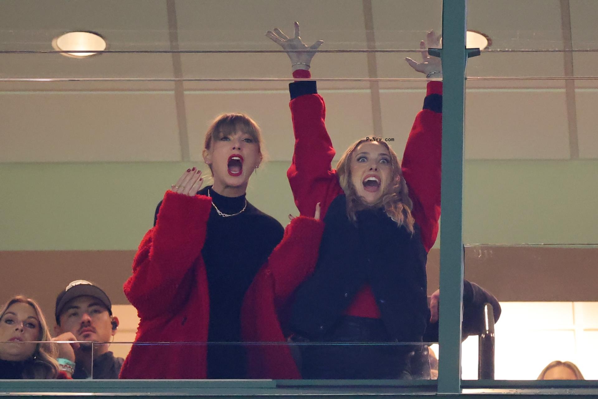 Taylor Swift and Brittany Mahomes cheering during a Chiefs game.
